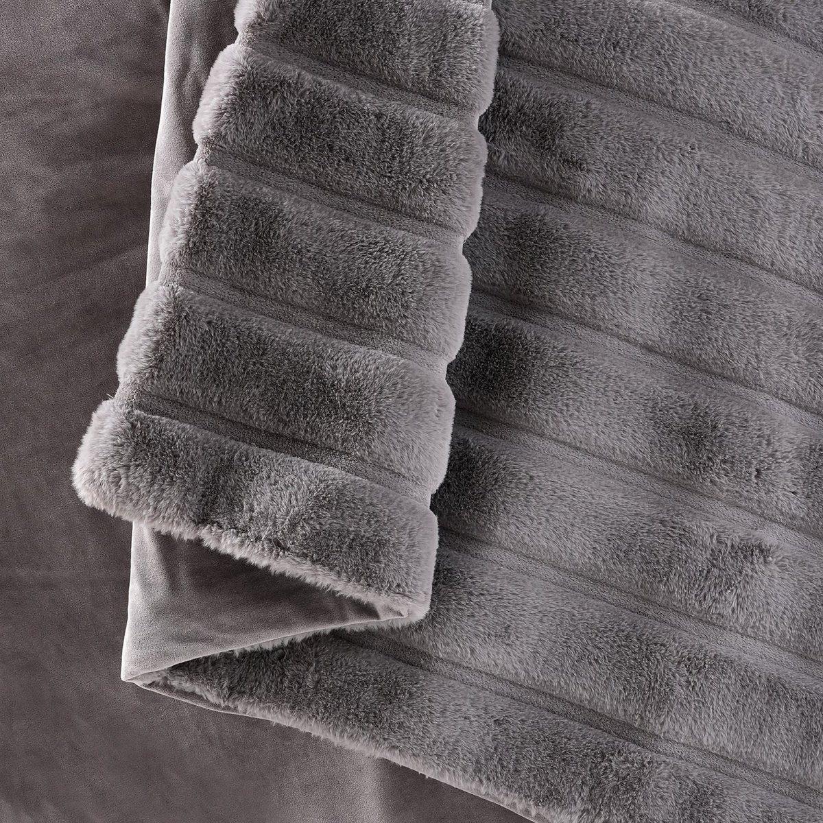 Detailed folded edge and plush ribbed texture of the Cozy Bliss faux fur throw blanket #color_Grey