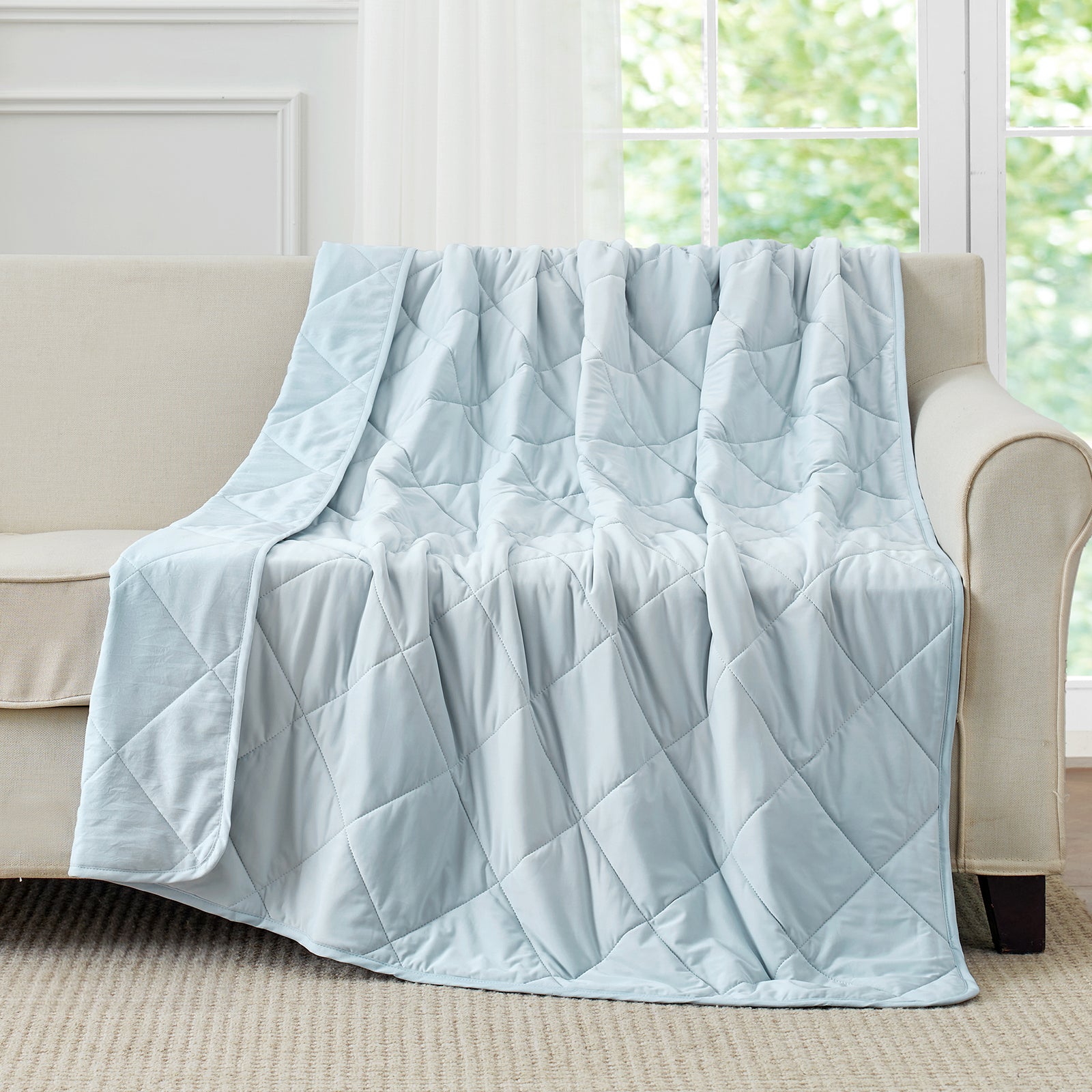 Light blue Chill Weave cooling blanket on a couch #Color_Cool Blue