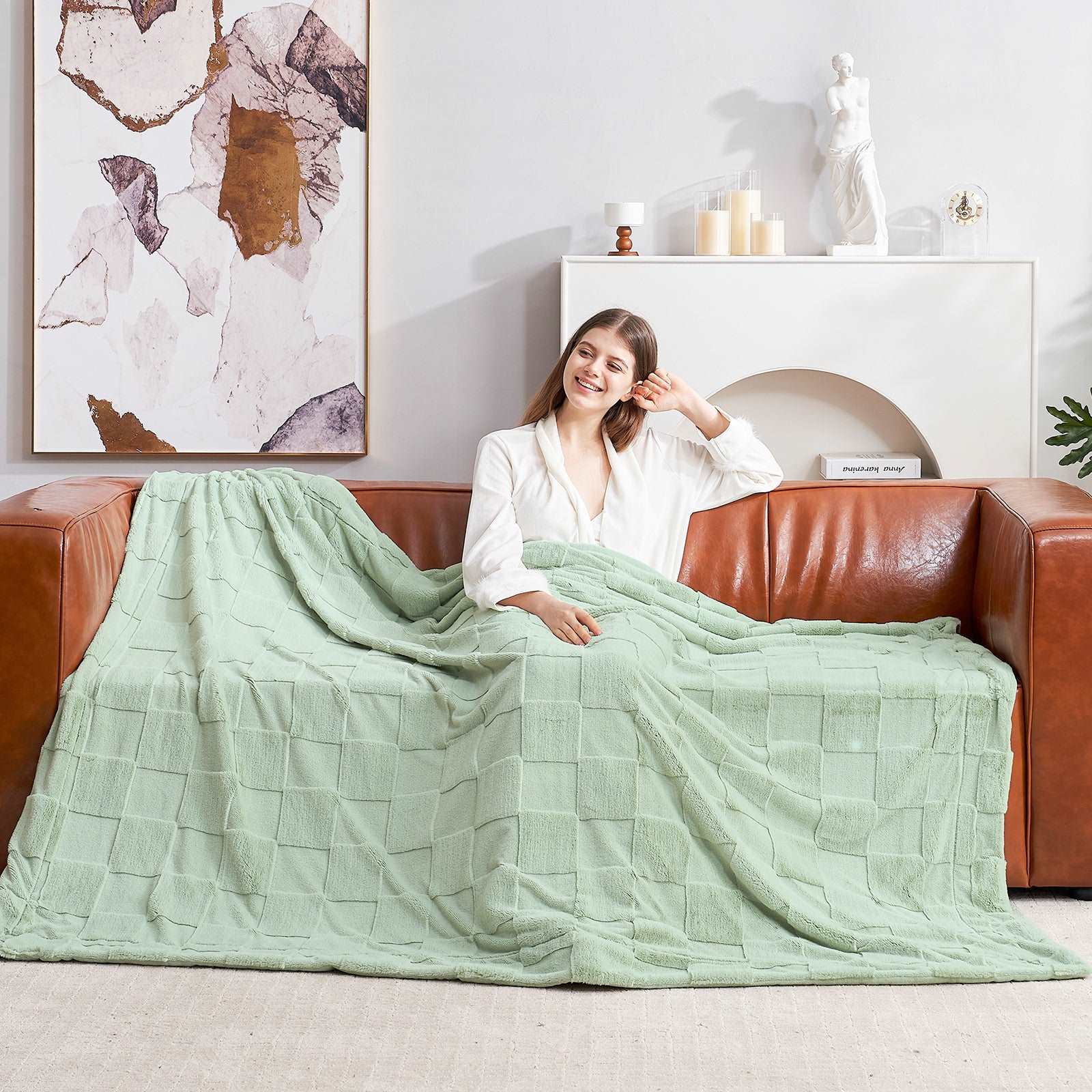 Woman relaxing with a Cozy Bliss green checkboard faux fur blanket #color_Sage Green