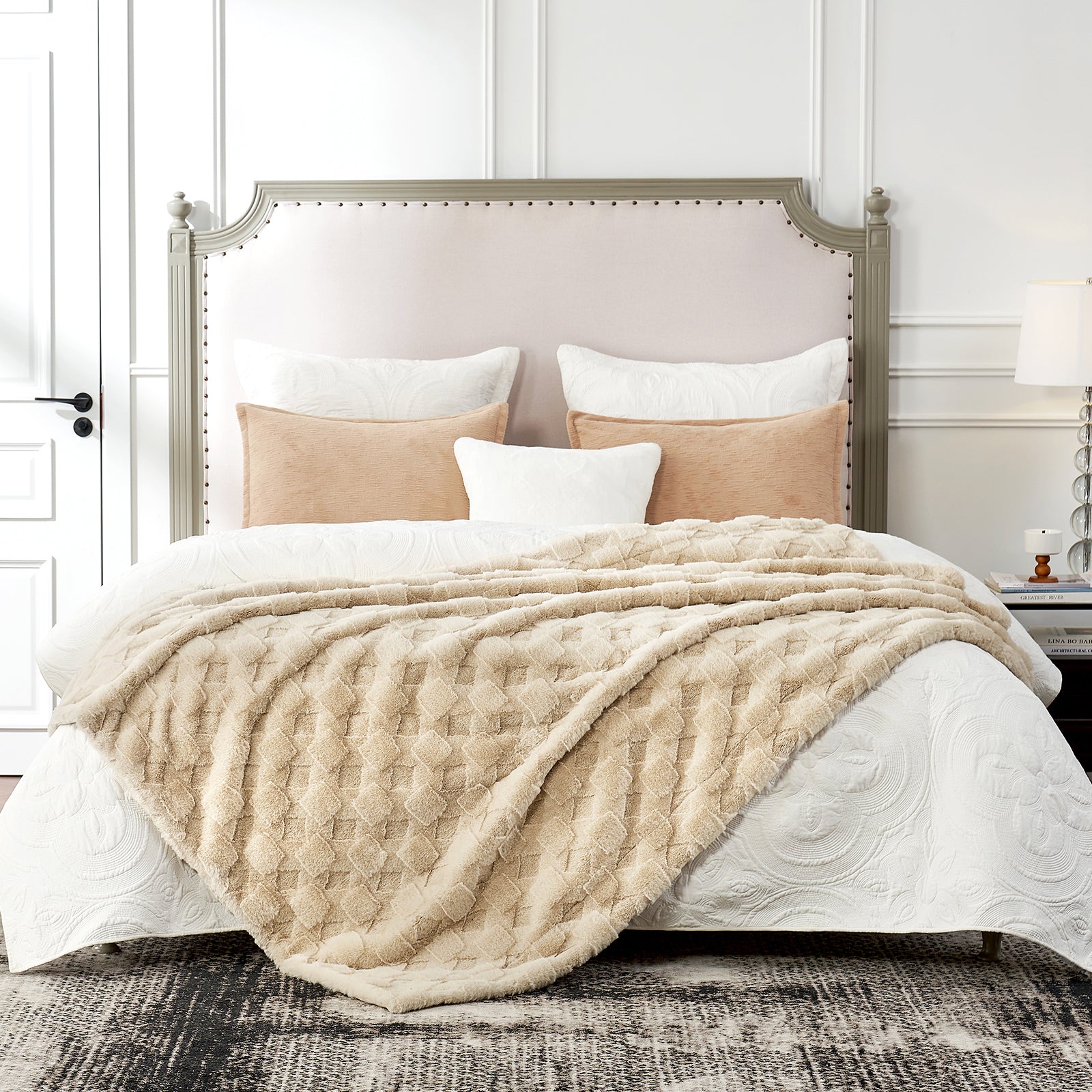 Neatly made bed with beige quilt and pillows in a bedroom setting #color_Beige