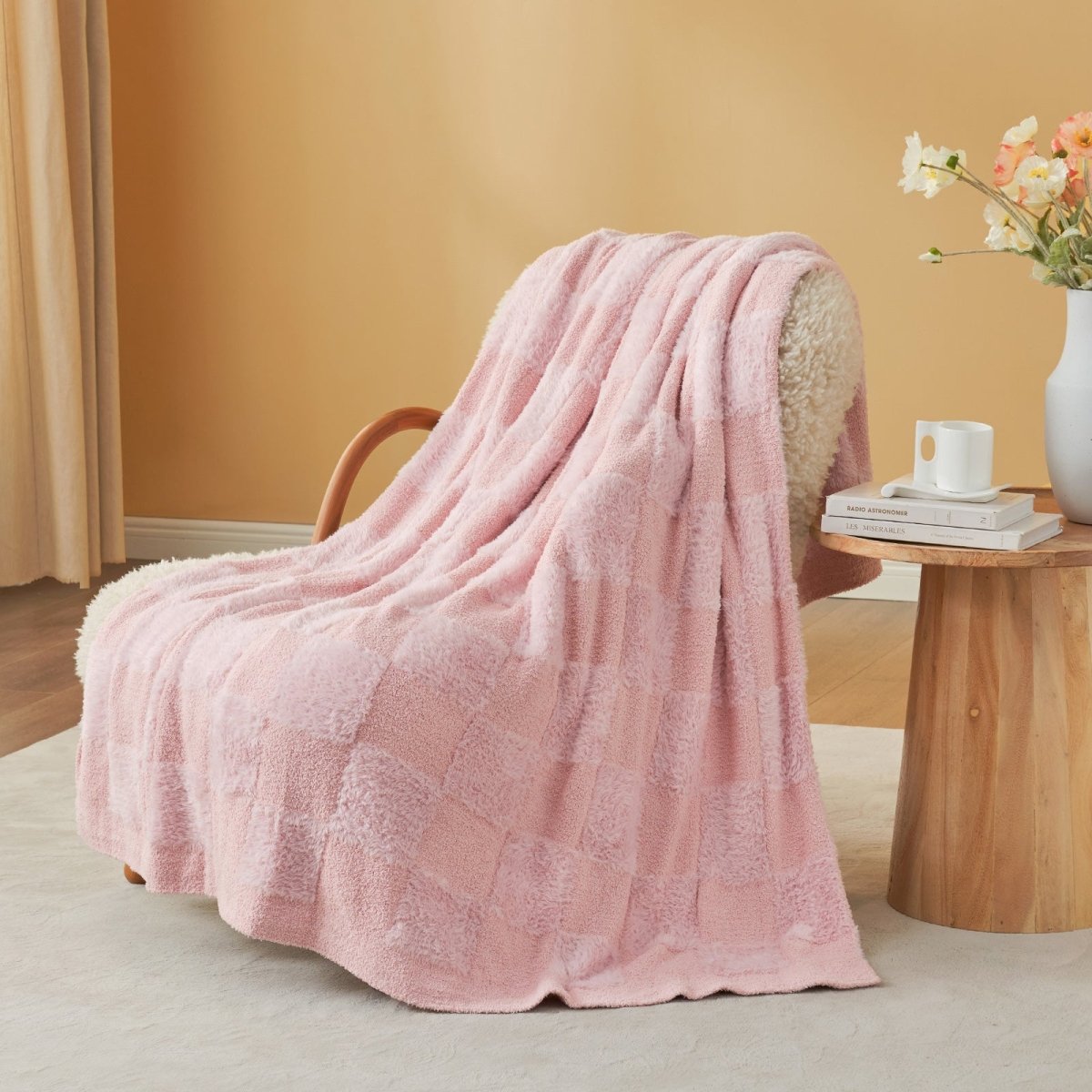 Checkered Faux Fur Feather Yarn Throw Blanket in Pink draped over an armchair, adding a soft and cozy vibe. #color_Pink