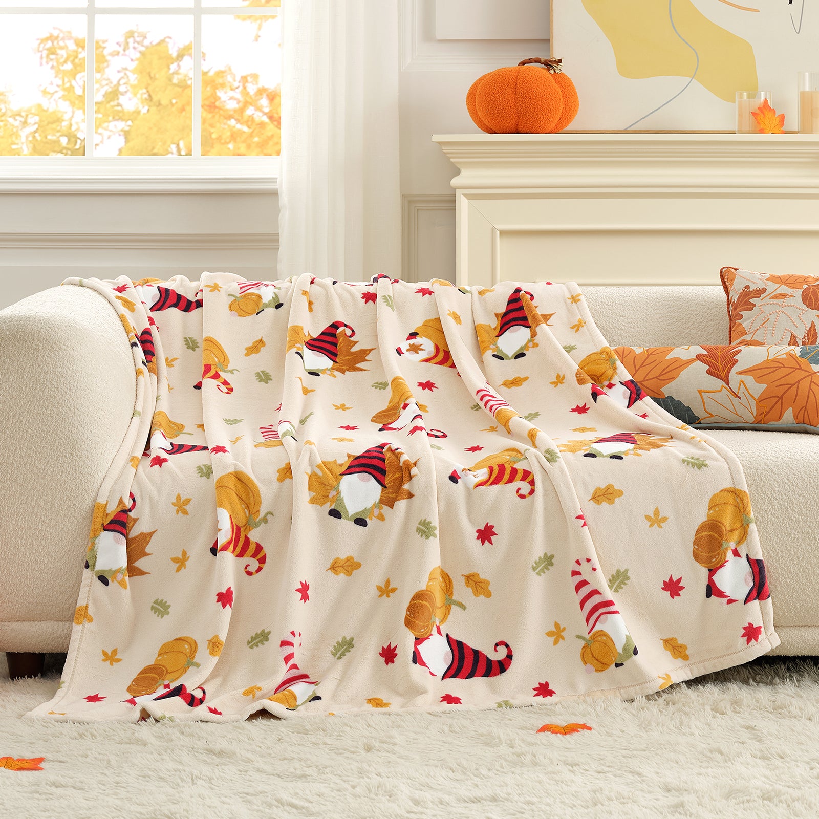 Decorative blanket with autumn-themed design on a couch in a cozy living room. #color_Pumpkin Gnome