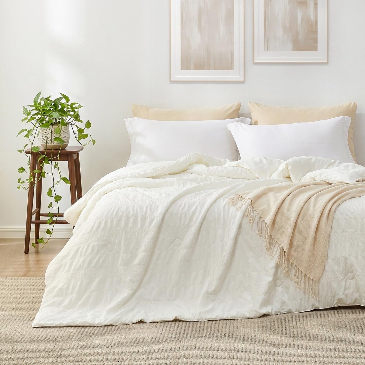 Cozy Bliss white seersucker cooling comforter on a bed in front view.#color_Cream White