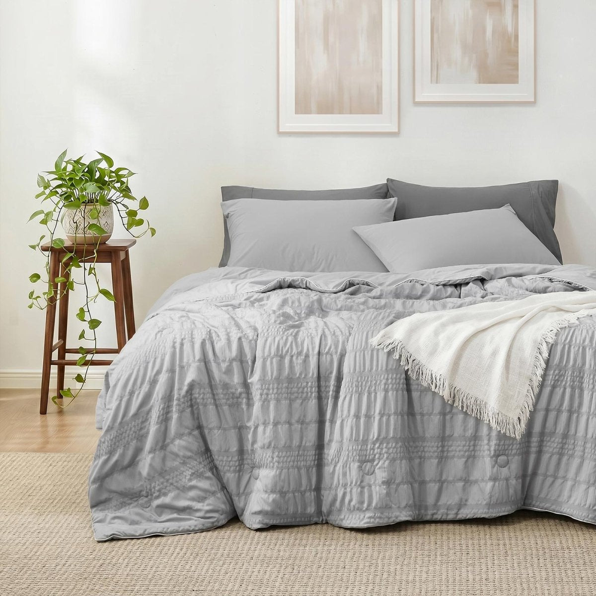 Cozy Bliss seersucker cooling comforter on a bed in front view.#color_Light Grey