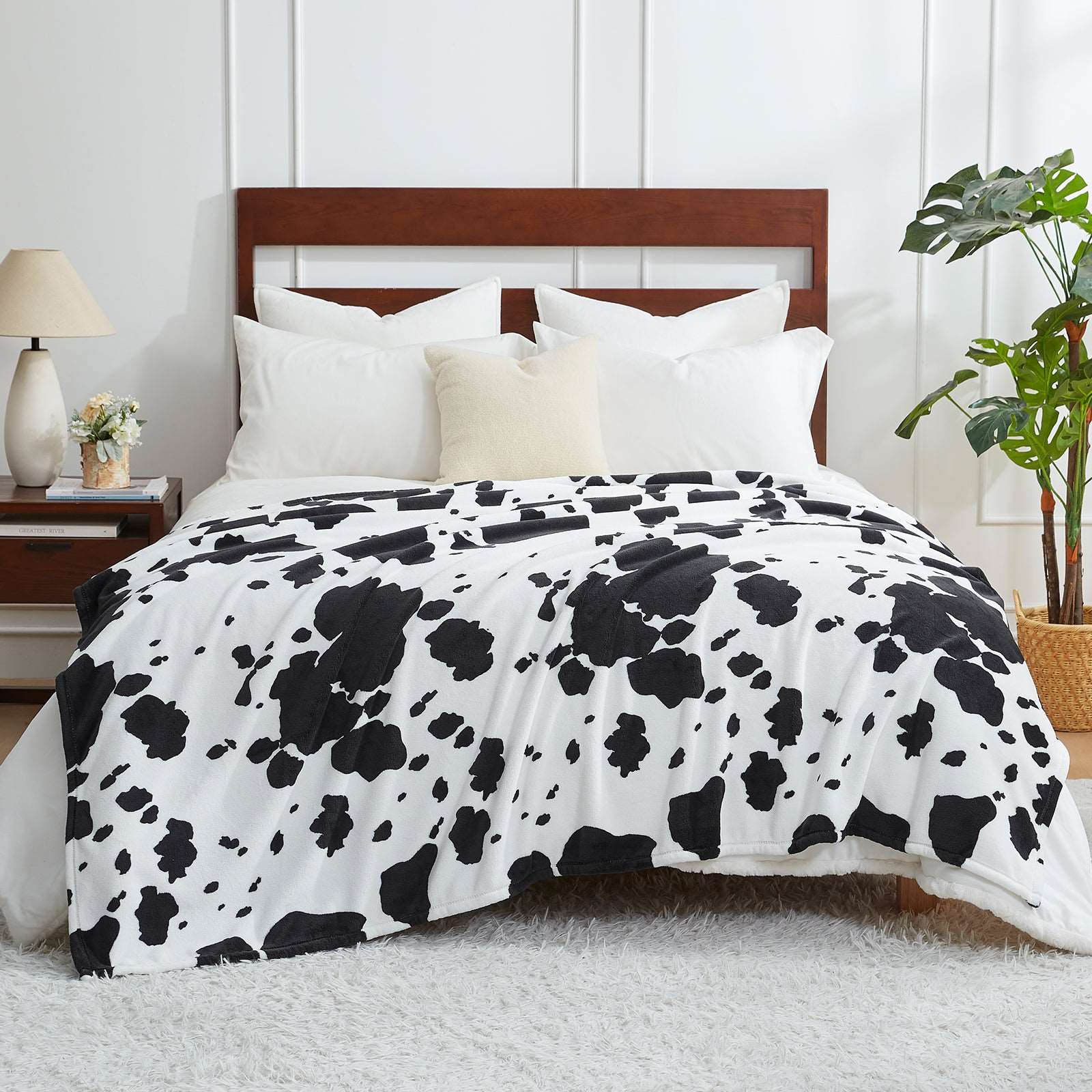 Cozy Bliss cow print blanket on bed #color_Black White