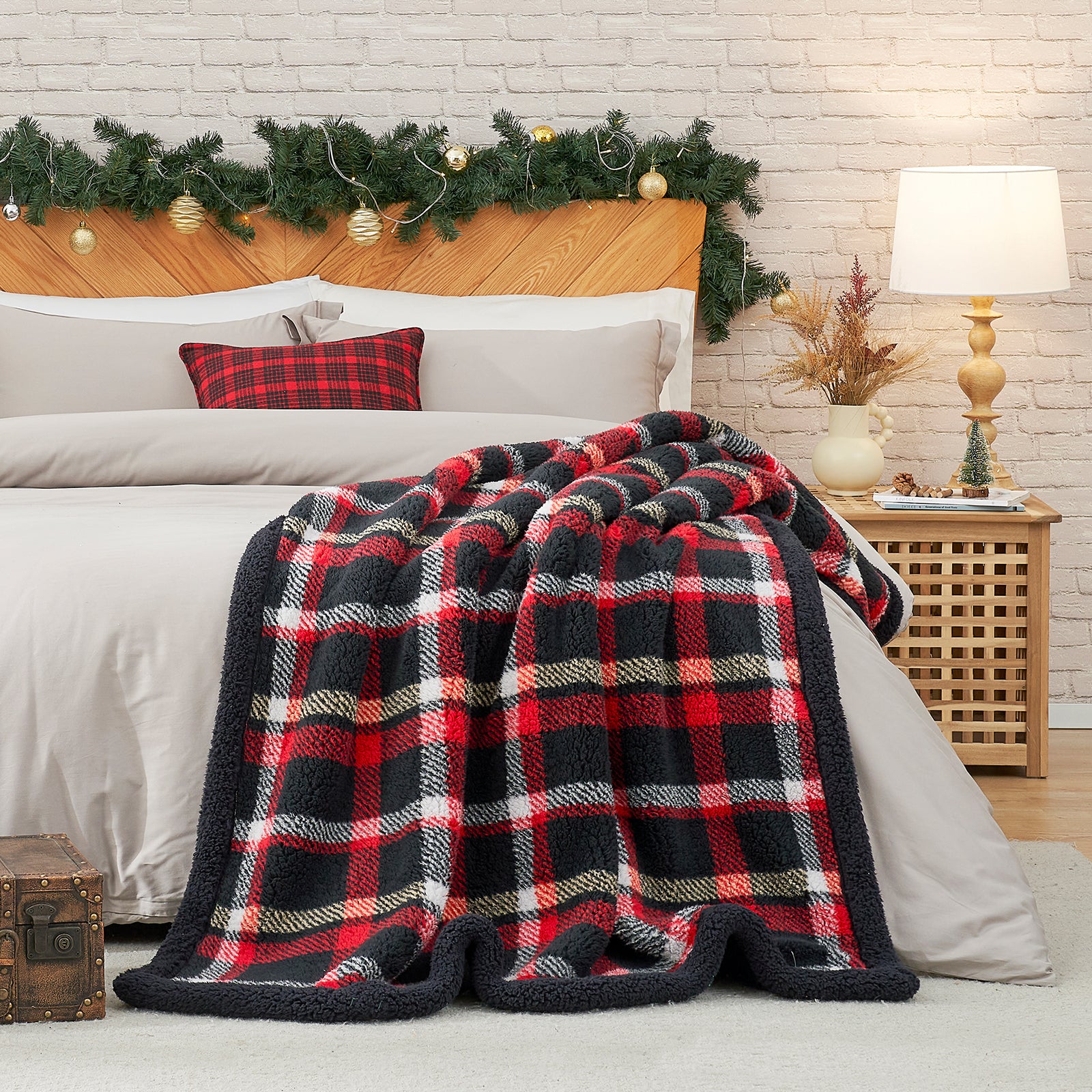 Plaid blanket draped over a bed with festive decorations in the background #Color_Scotland Plaid Red