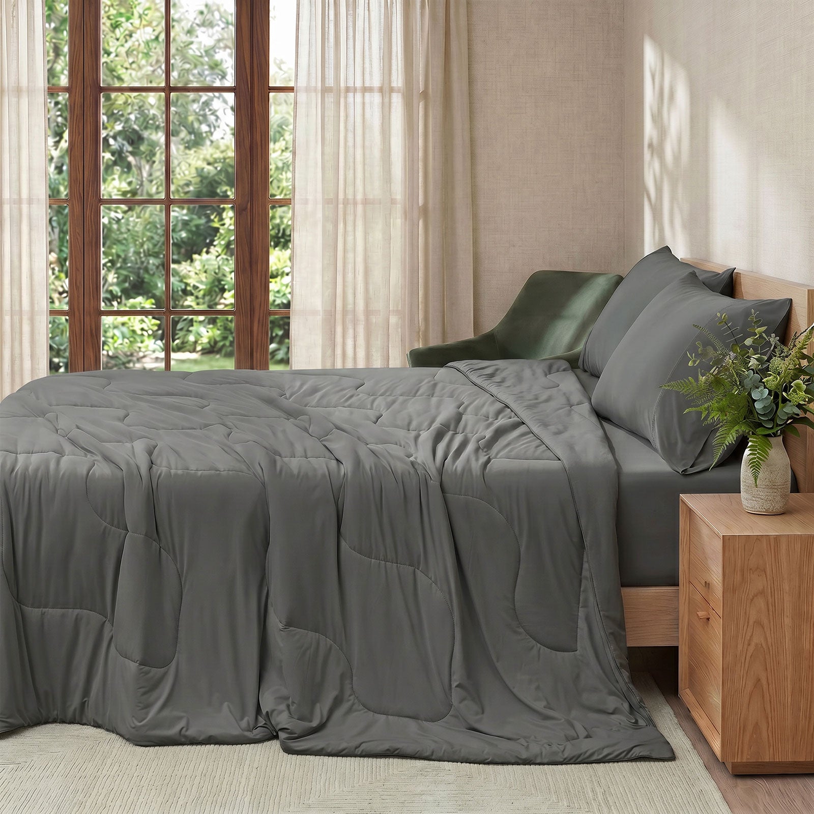 Cozy Bliss natural fiber cooling comforter on a bed in side view.#color_Charcoal Grey