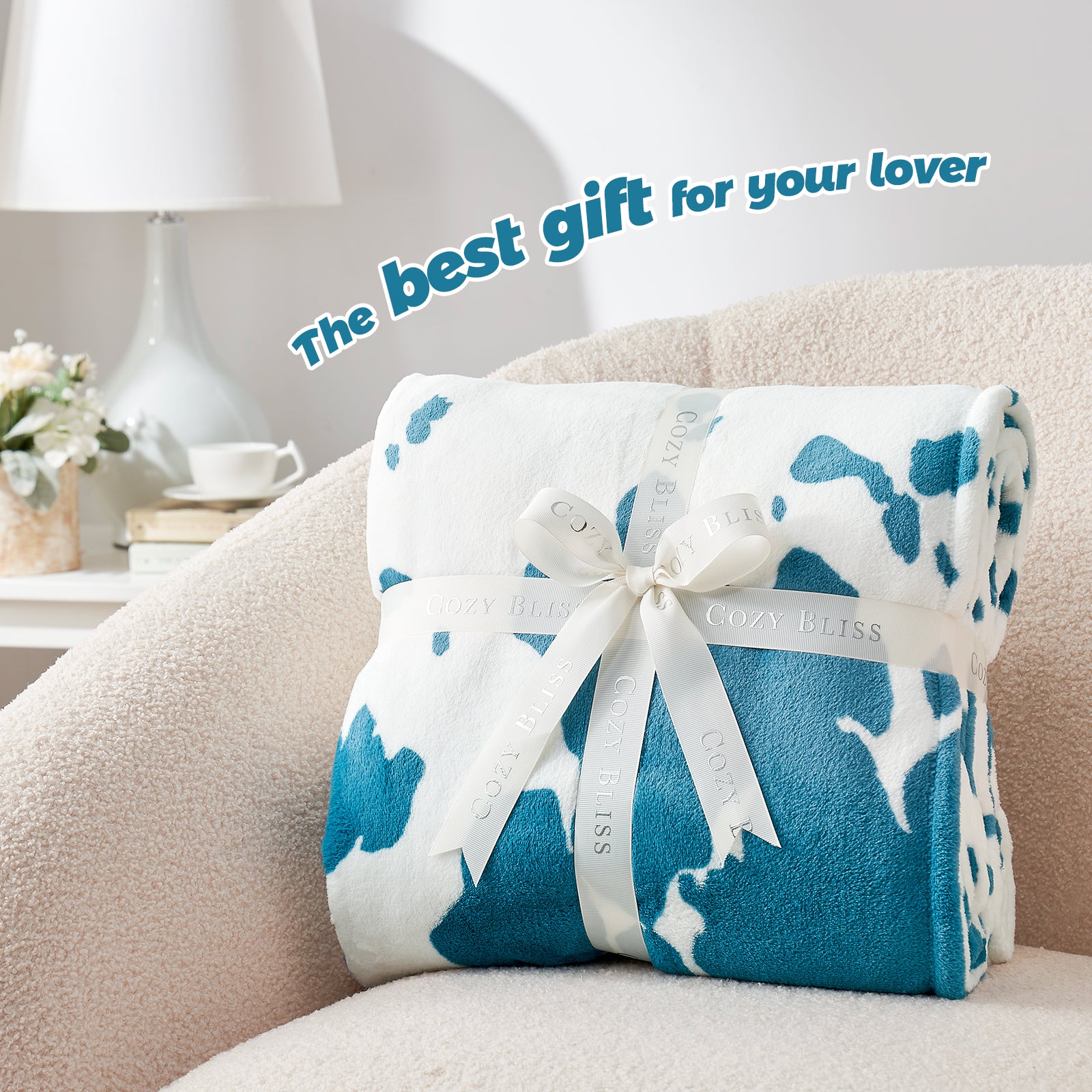 Folded blue and white blanket with a bow on a couch, text 'The best gift for your lover' above.  #color_Blue