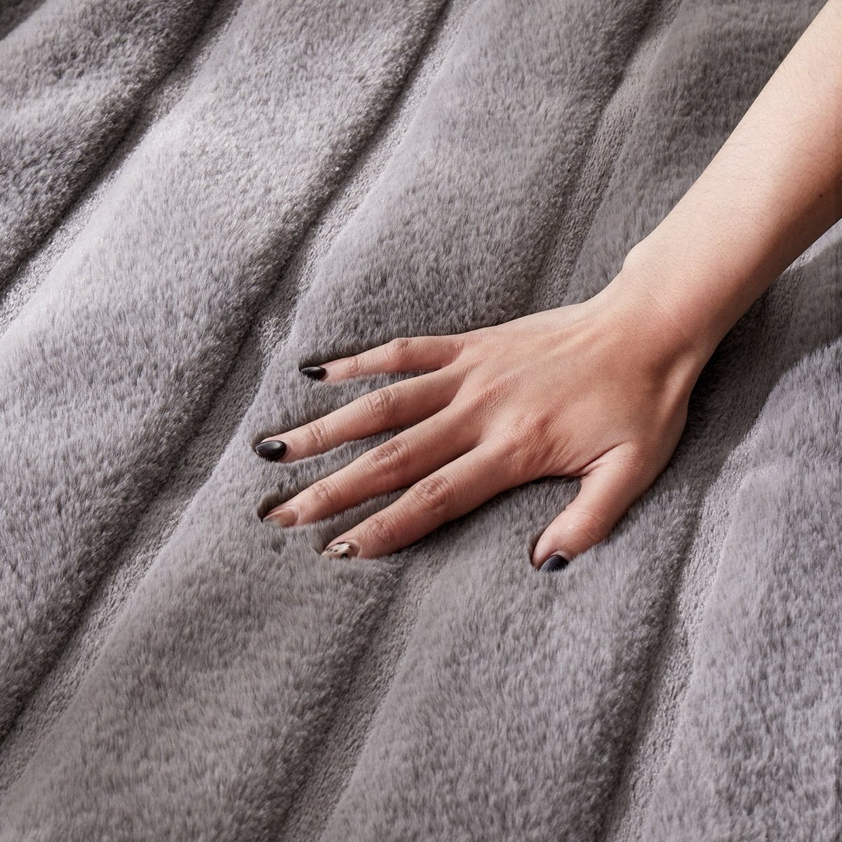 Close-up of Cozy Bliss faux fur blanket texture with ultra-soft hand feel #color_Grey