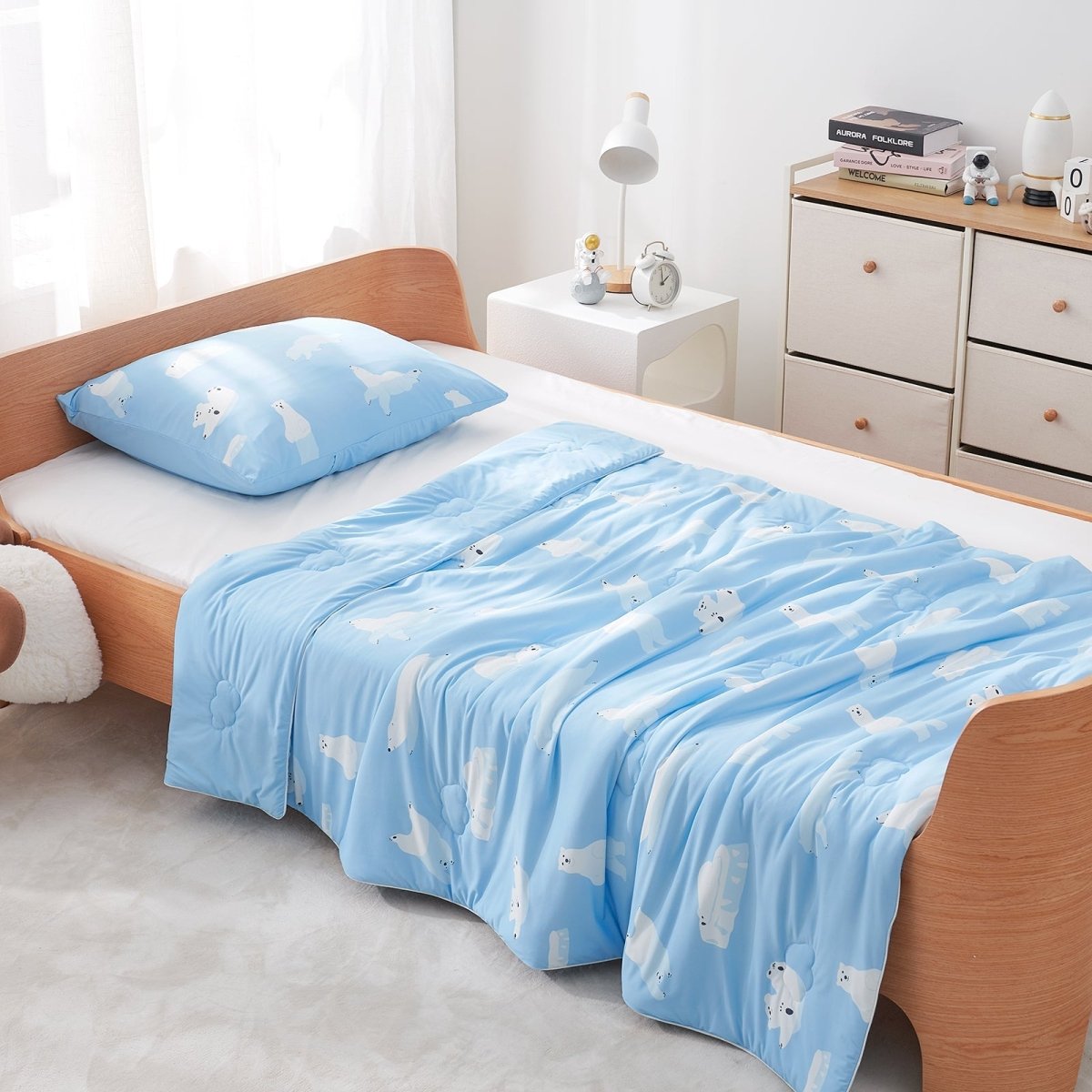 Blue comforter and pillows in a bedroom setting#color_Polar Bear