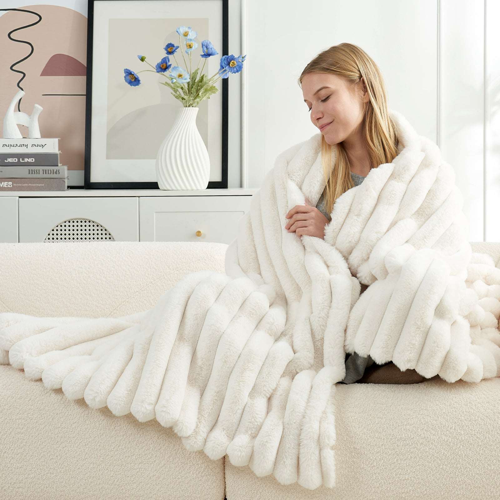 Woman wrapped in a cozy white faux fur blanket  #color_Cream White