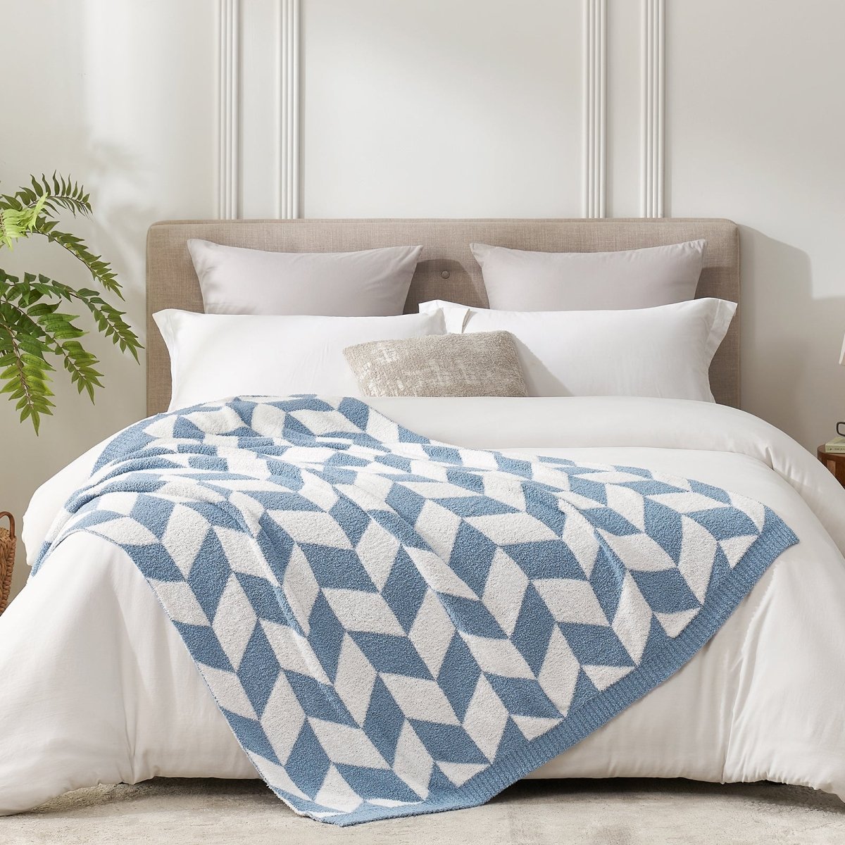 Chevron Feather Yarn Knit Throw Blanket in Blue styled on a bed, highlighting soft texture and modern chevron pattern in a bright bedroom setting. #color_Misty Blue
