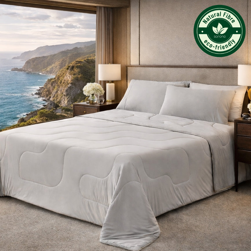 Woman sleeping under Cozy Bliss cooling comforter, promoting sweat-free sleep, featuring breathable design. #color_Cool Grey