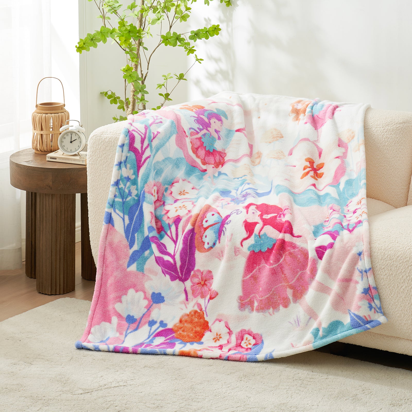 Colorful floral blanket draped over a couch in a living room setting. #color_Garden Fairy