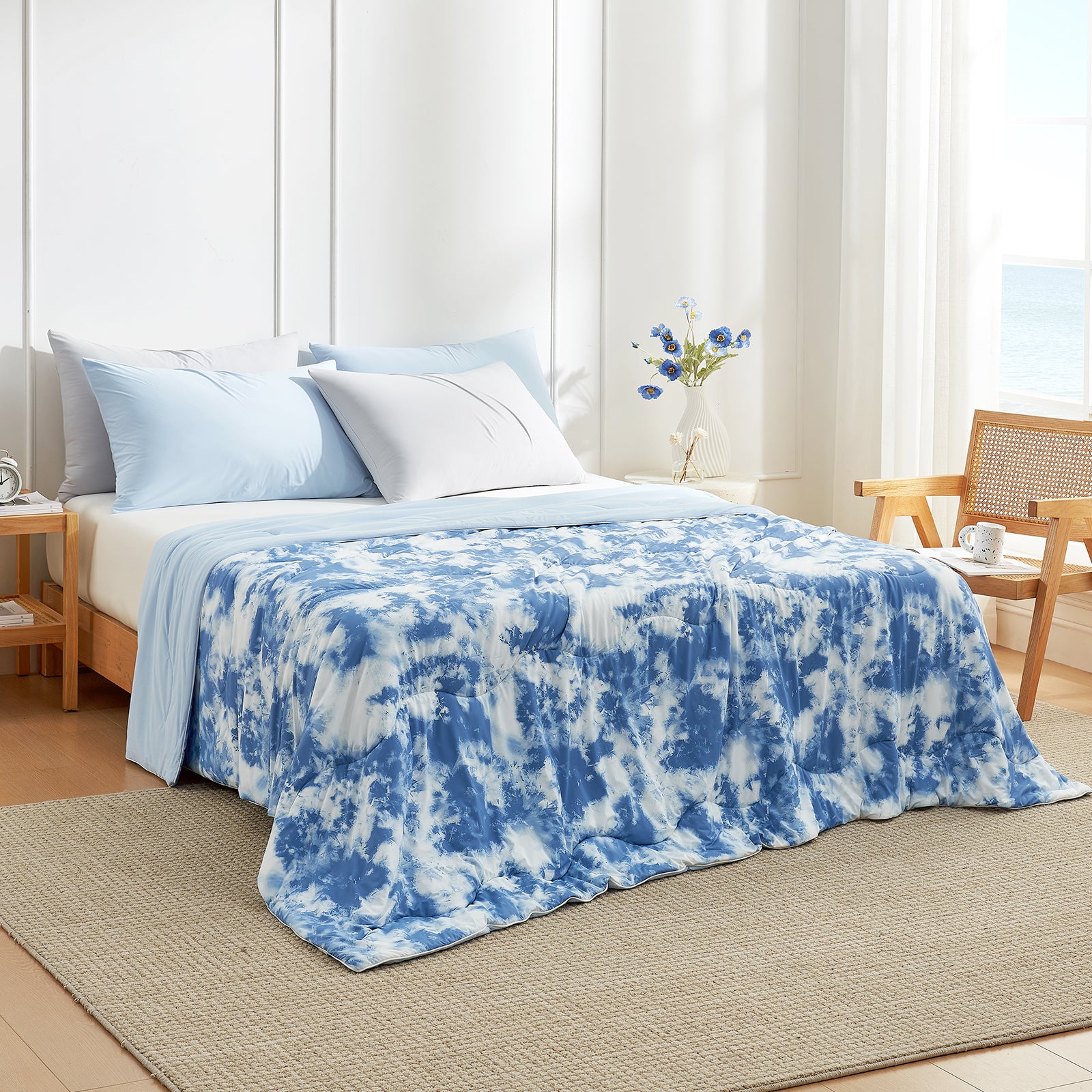 Bed with blue and white tie-dye blanket in a bright bedroom #Color_Tie-dye Blue