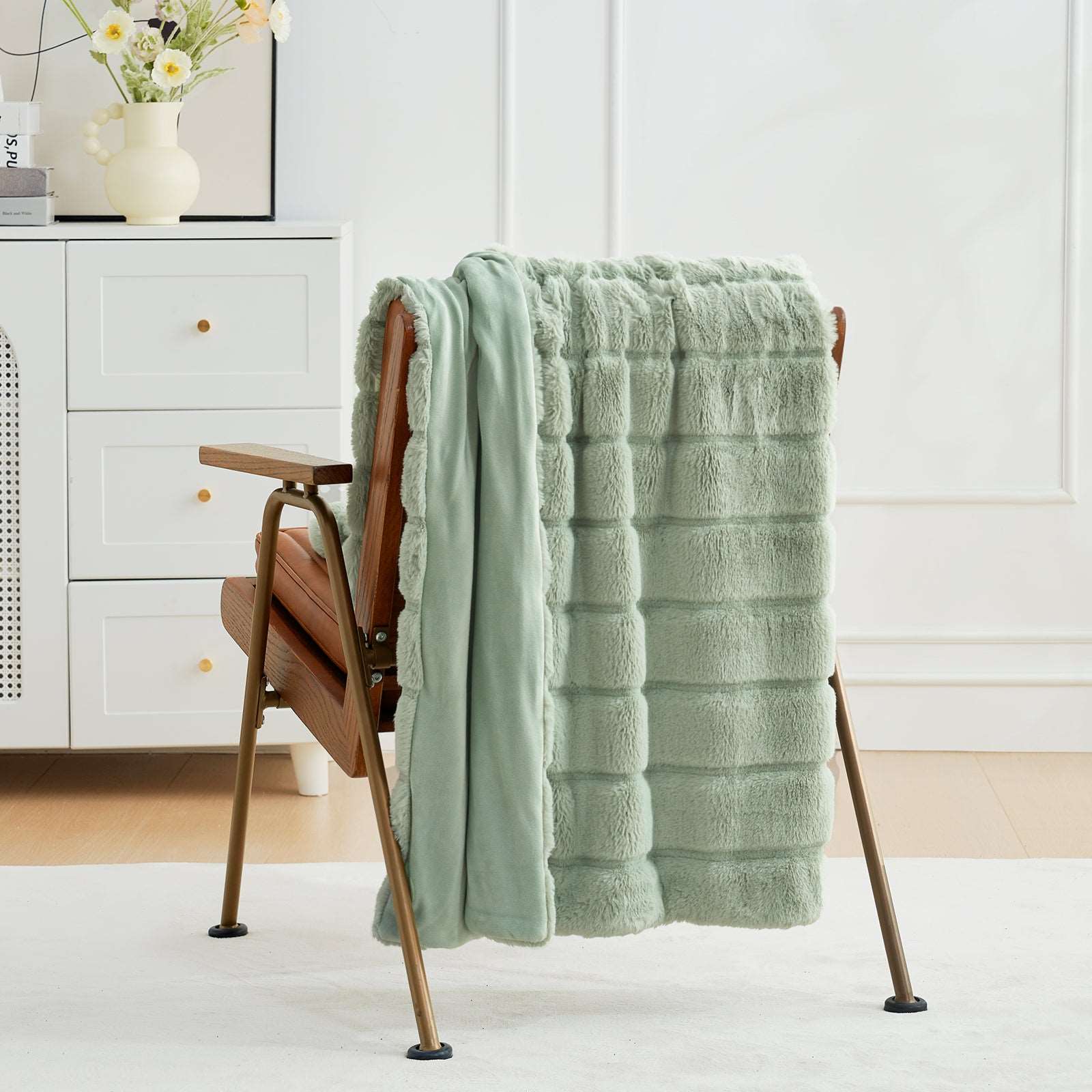 Cozy Bliss sage green faux fur throw blanket on a wooden chair  #color_Sage Green