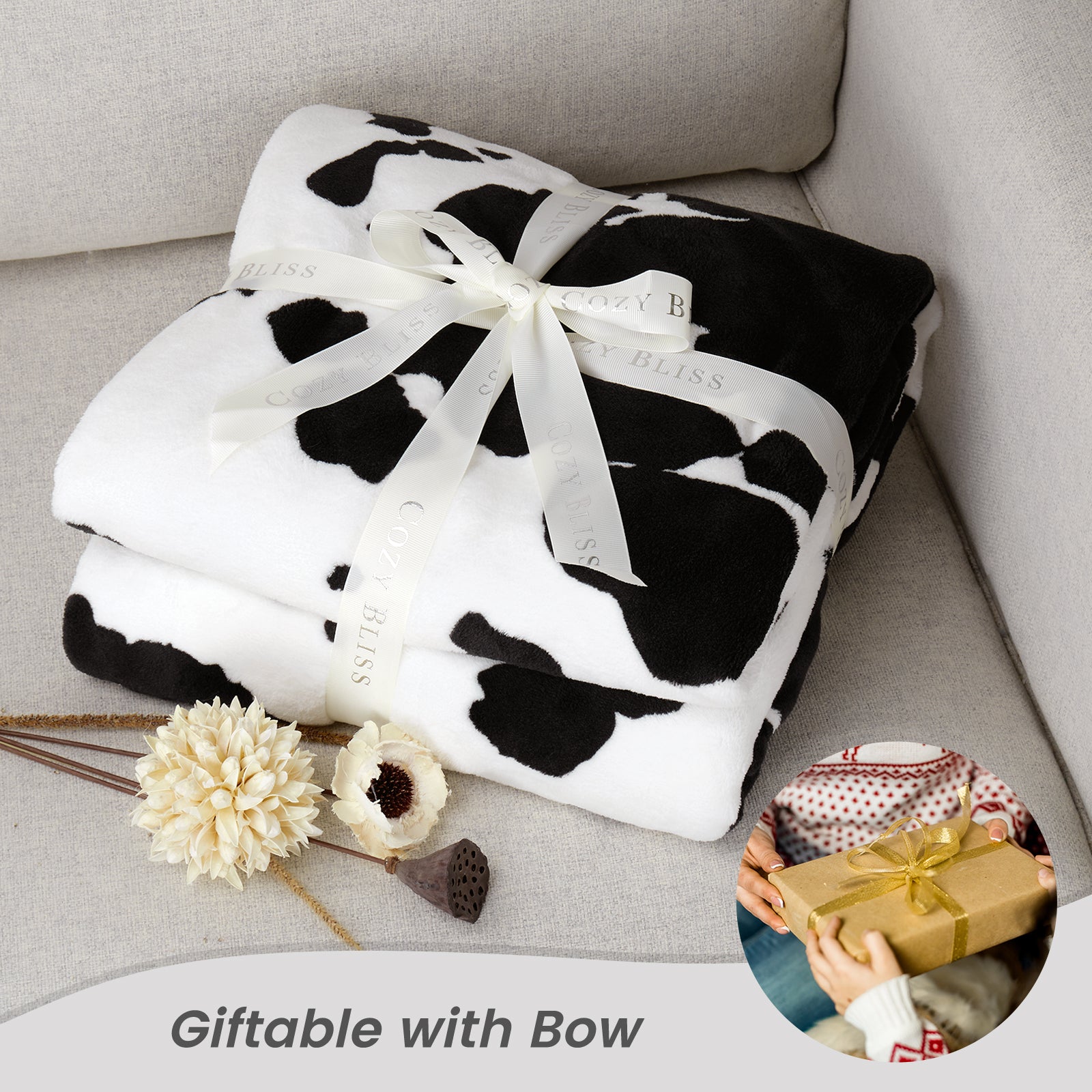 Cow print blanket with a bow on a couch, gift-wrapped with a bow. #color_Black White