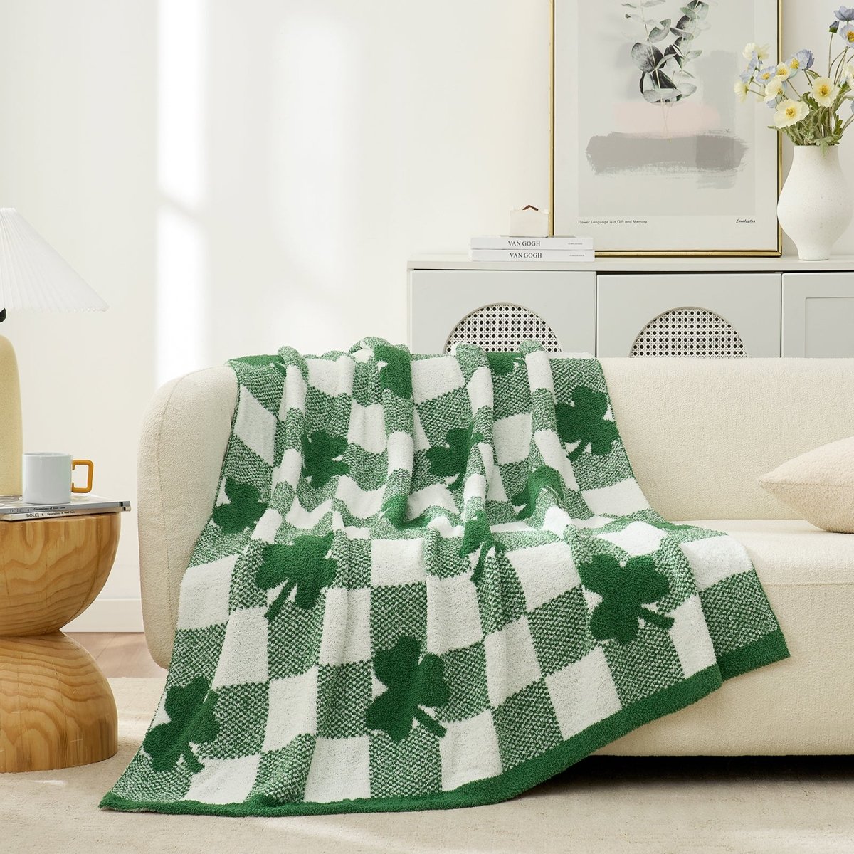 Green and white checkered blanket with shamrocks on a beige sofa in a living room in front view #color_Xmas Green