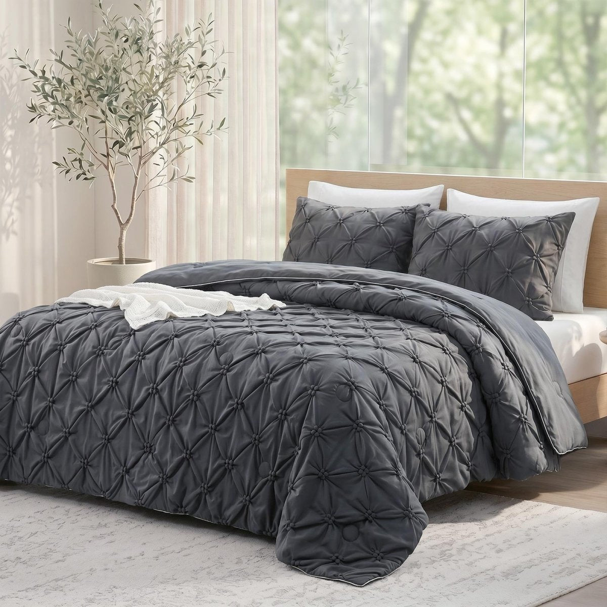Cozy Bliss grey pintuck design cooling comforter on a bed, designed for hot sleepers and night sweats.#color_Charcoal Grey
