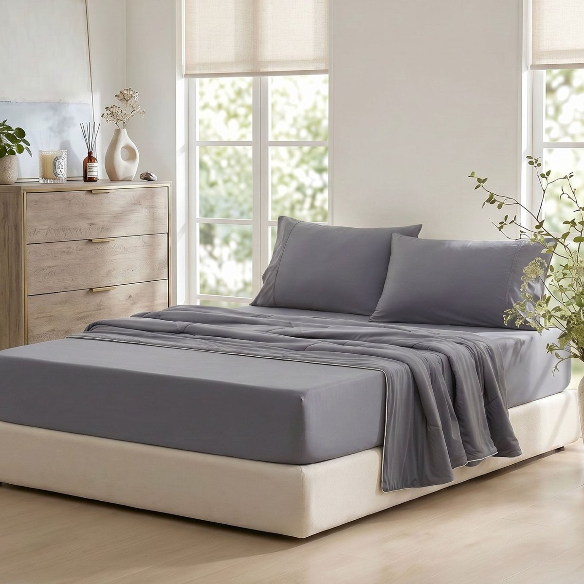 Cozy Bliss dark gray cooling sheet set on bed with pillowcases in side view.#Color_Dark Grey