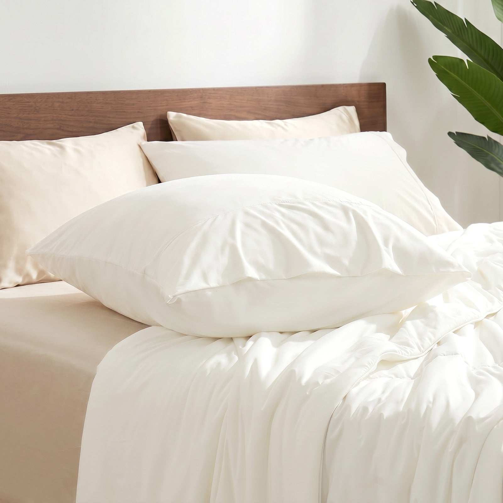 Cozy Bliss envelope cooling pillowcases on bed.#color_Off White
