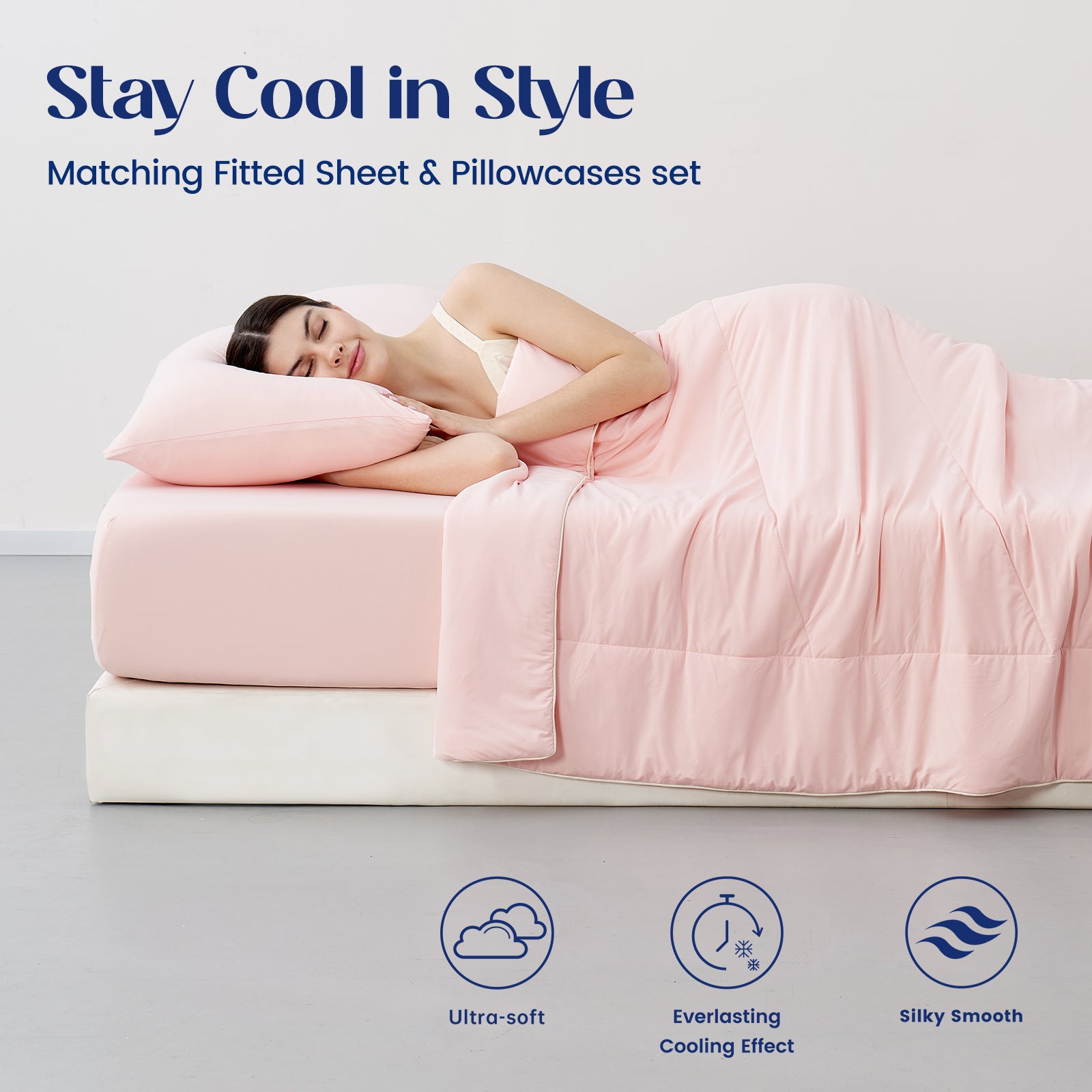 Woman lying on a cooling sheet set with matching fitted sheet and pillowcases set.#color_Pink