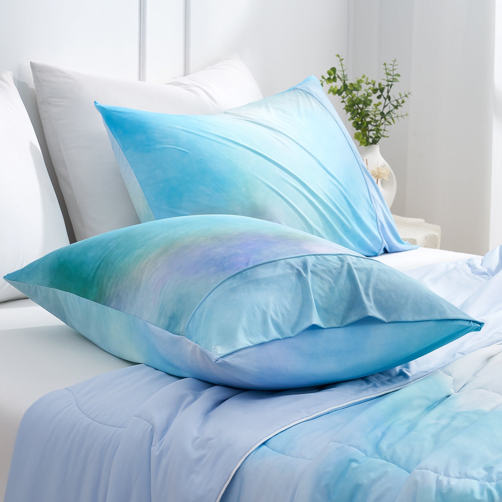Blue watercolor cooling pillowcases, soft and breathable, perfect for a cozy bedroom.