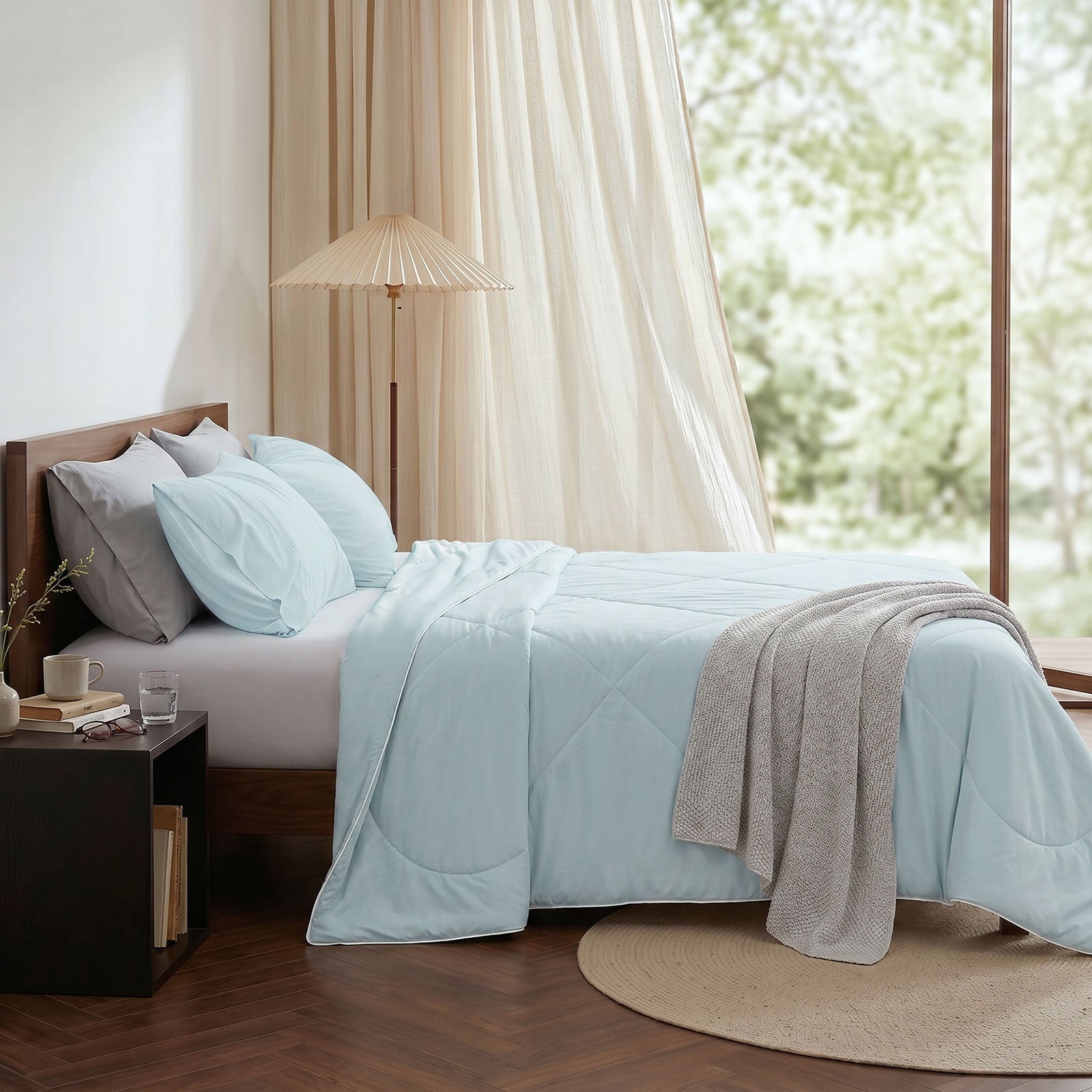 Cozy Bliss cooling comforter on bed in side view. Breathable, soft fabric for hot sleepers. #Color_Cool Blue