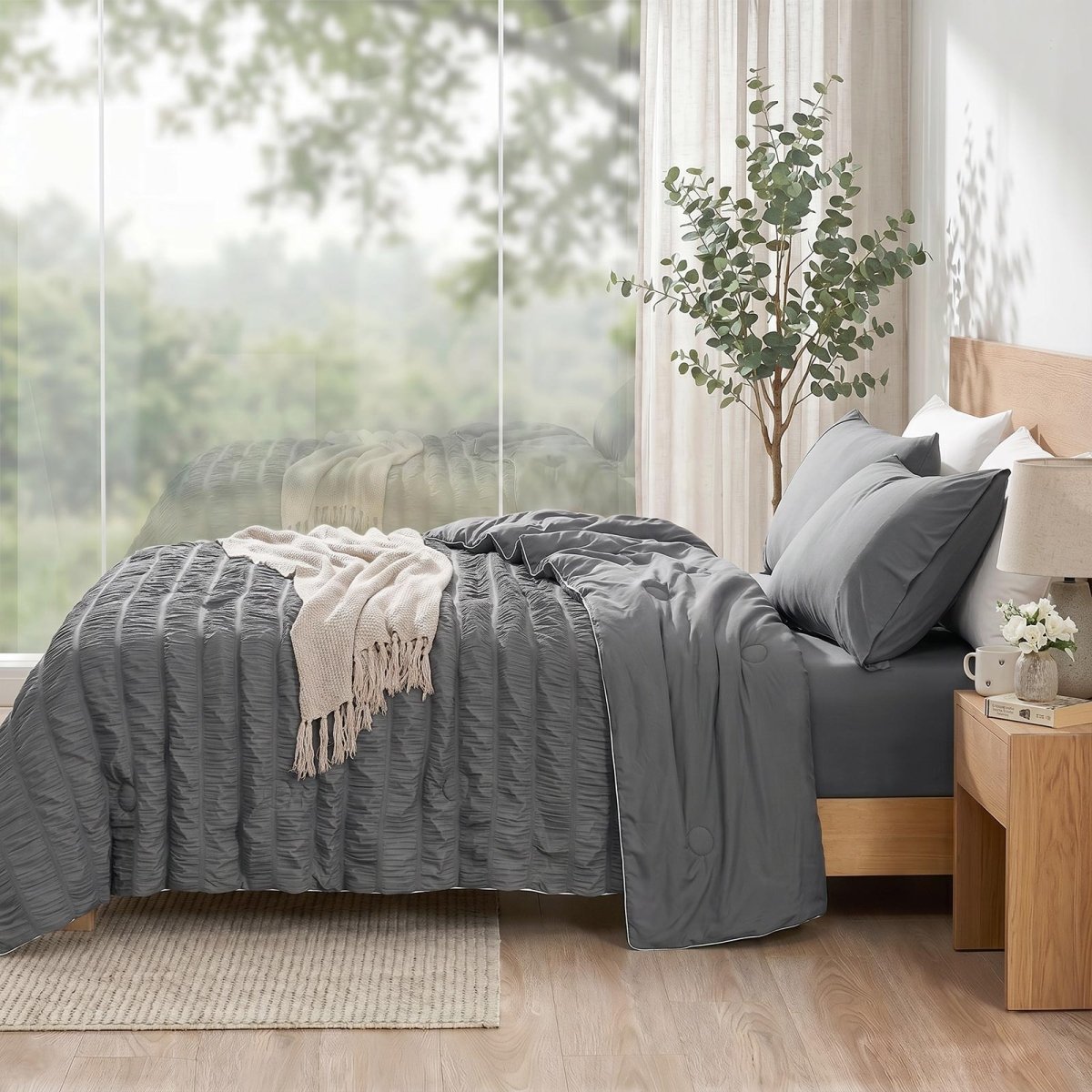 Cozy Bliss vertical striped seersucker cooling comforter in side view.#color_Charcoal Grey