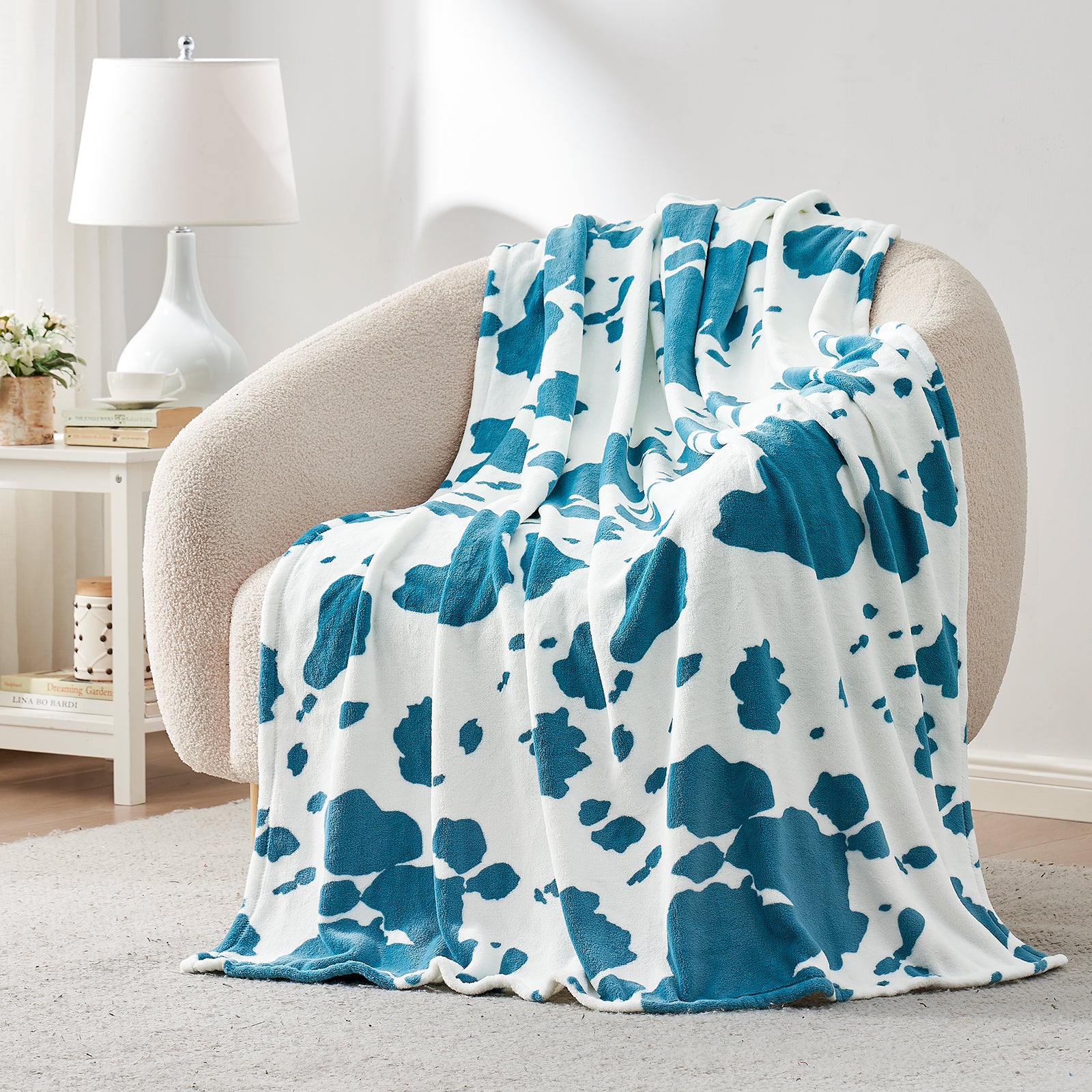 Blue and white patterned blanket draped over a chair in a living room setting.  #color_Blue