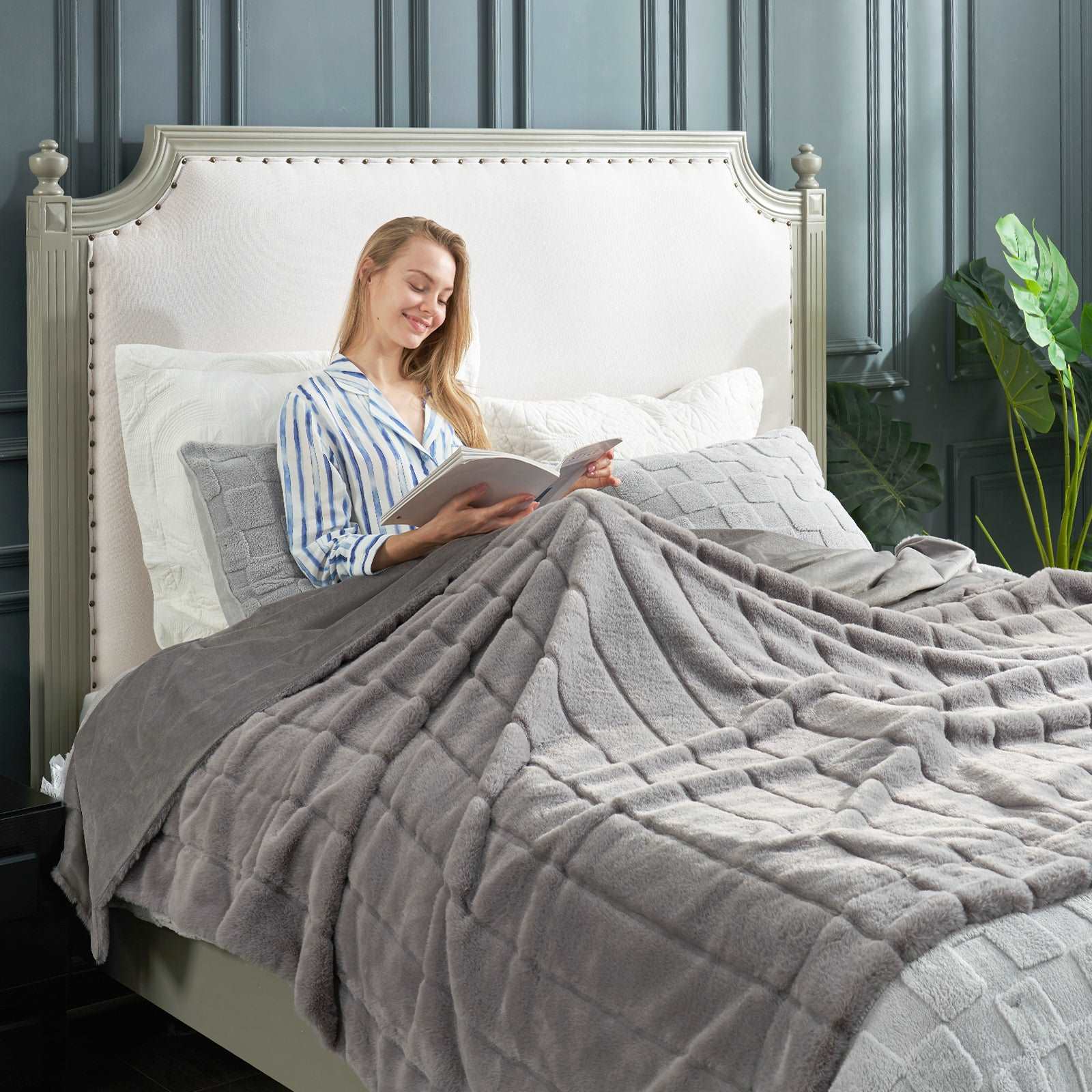 Woman reading in bed with Cozy Bliss gray faux fur blanket  #color_Grey