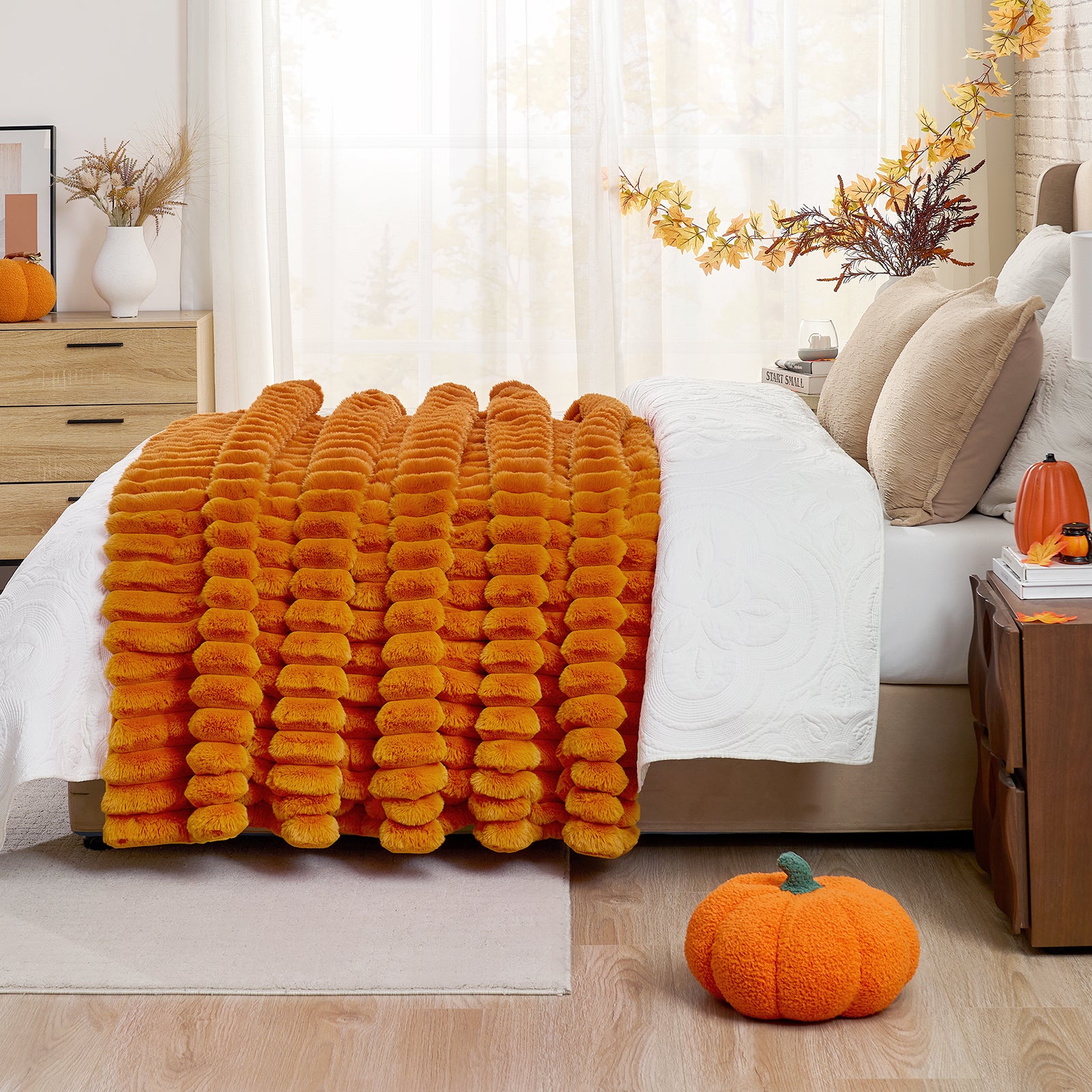 Orange fluffy blanket on a bed with pumpkins and decorative elements in a bedroom setting.  #color_Burnt Orange
