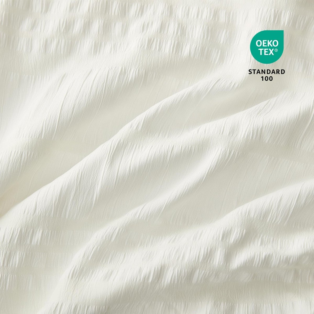 Close-up of Cozy Bliss white fabric with OEKO-TEX Standard 100 certification.#color_Cream White