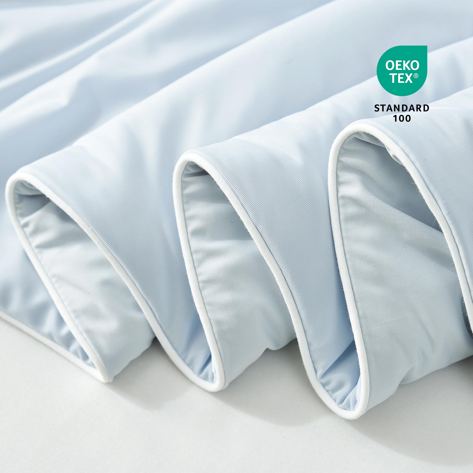 Close-up of blue fabric with Oeko-Tex Standard 100 certification.#color_Cool Blue