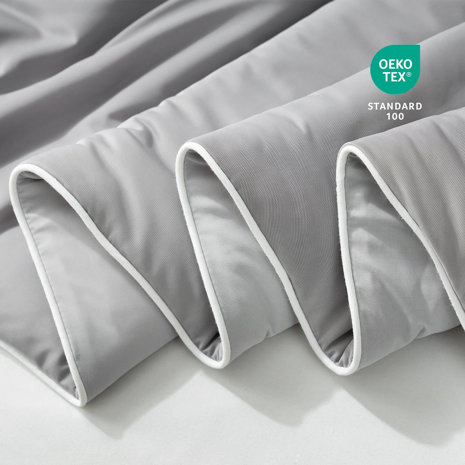 Close-up of grey fabric with Oeko-Tex Standard 100 certification.#color_Cool Grey