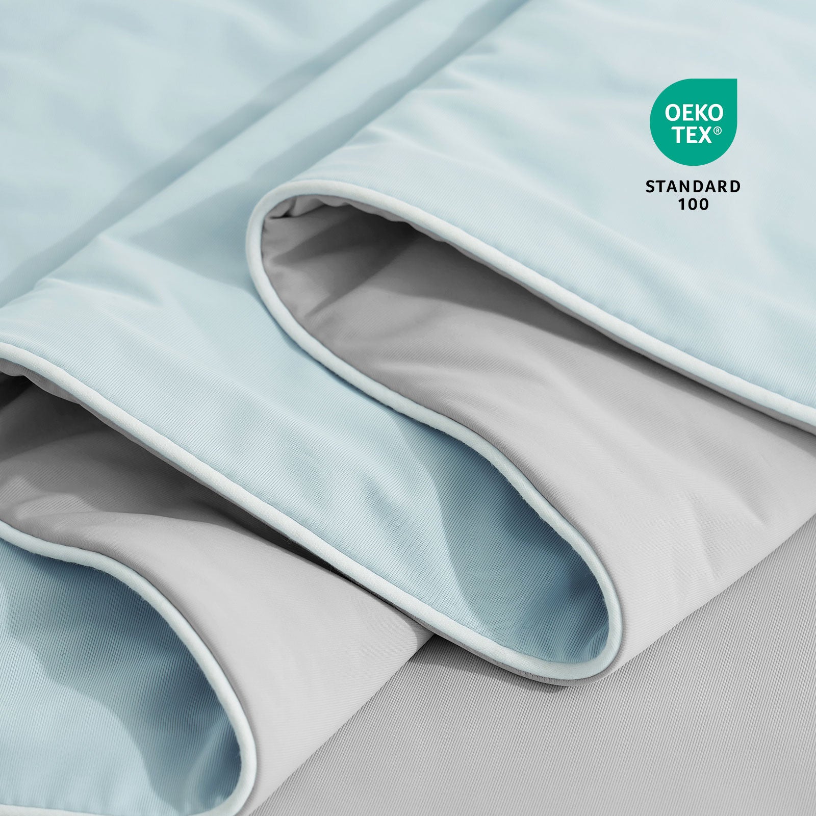 Close-up of OEKO-TEX certified cooling comforter fabric. #Color_Grey/Blue