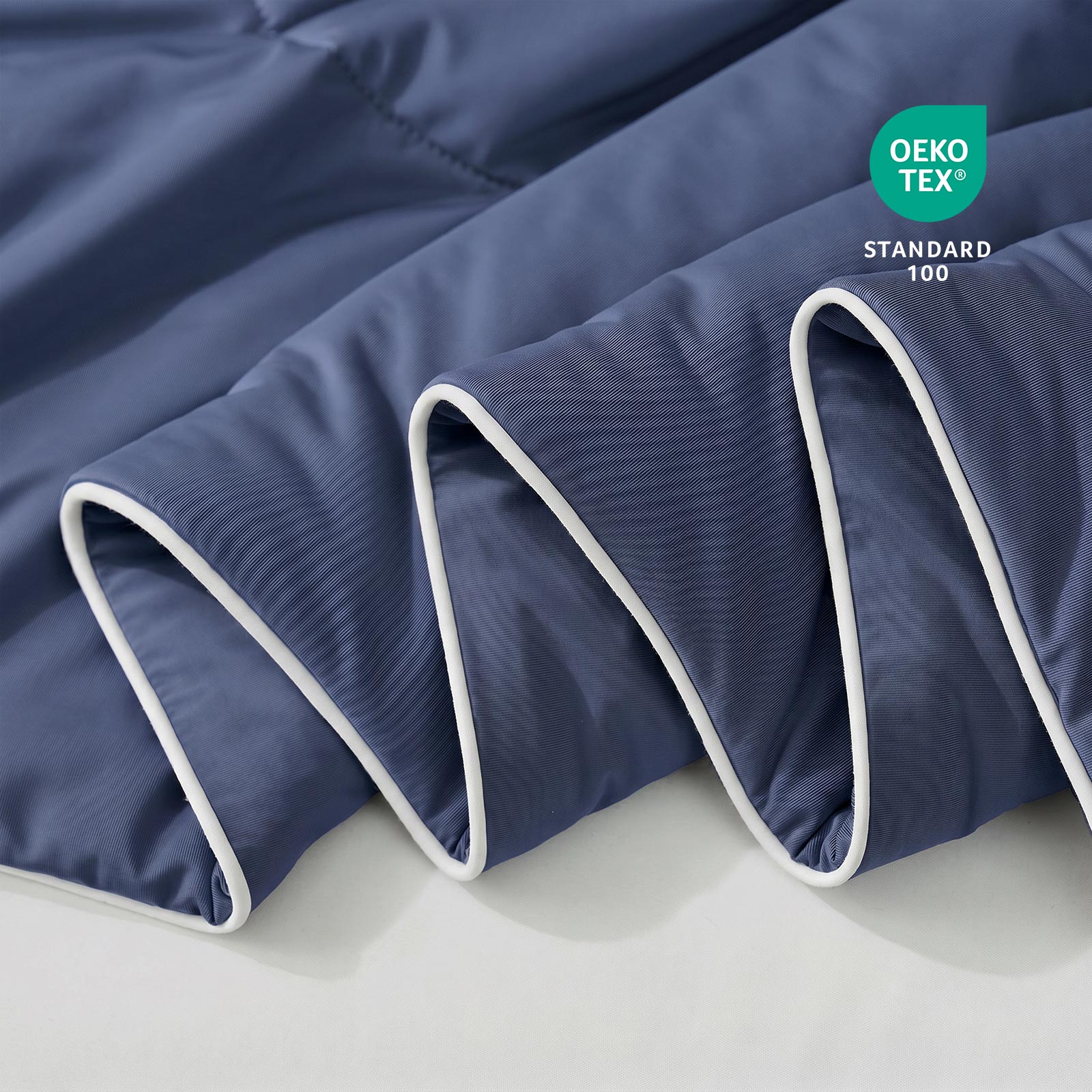 Close-up of blue fabric with Oeko-Tex Standard 100 certification.#color_Navy Blue
