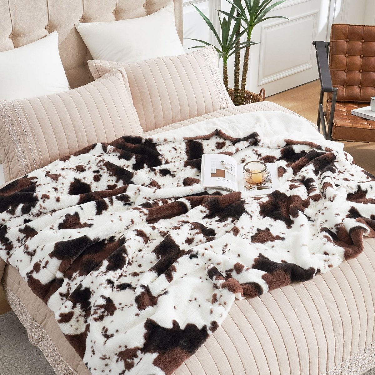 Cow print faux fur blanket on bed. Stylish and cozy bedding with a luxurious design for a modern bedroom #color_Black/Coffee Cow