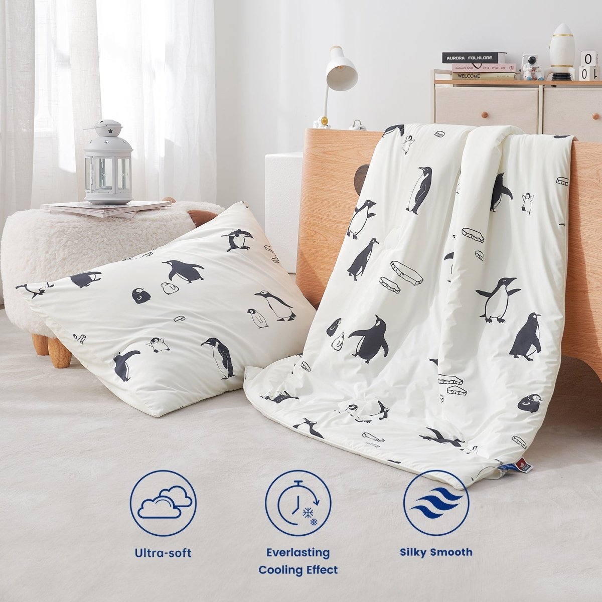 Penguin-patterned pillow and comforter set on a bed with product features displayed.#color_Antarctic Penguin