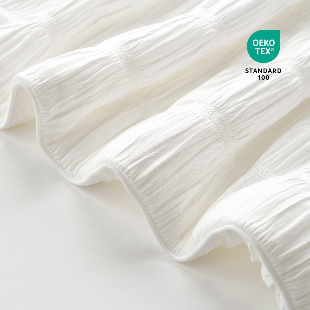 Close-up of OEKO-TEX Standard 100 certified fabric.#color_Off White