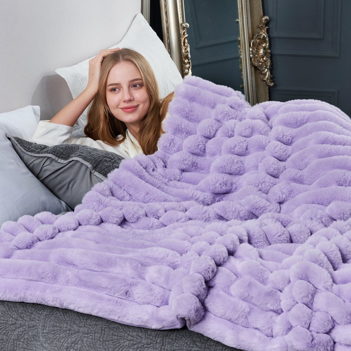 Woman relaxing on a bed with Cozy Bliss purple striped faux fur blanket, cozy bedding and soft blanket #color_Purple
