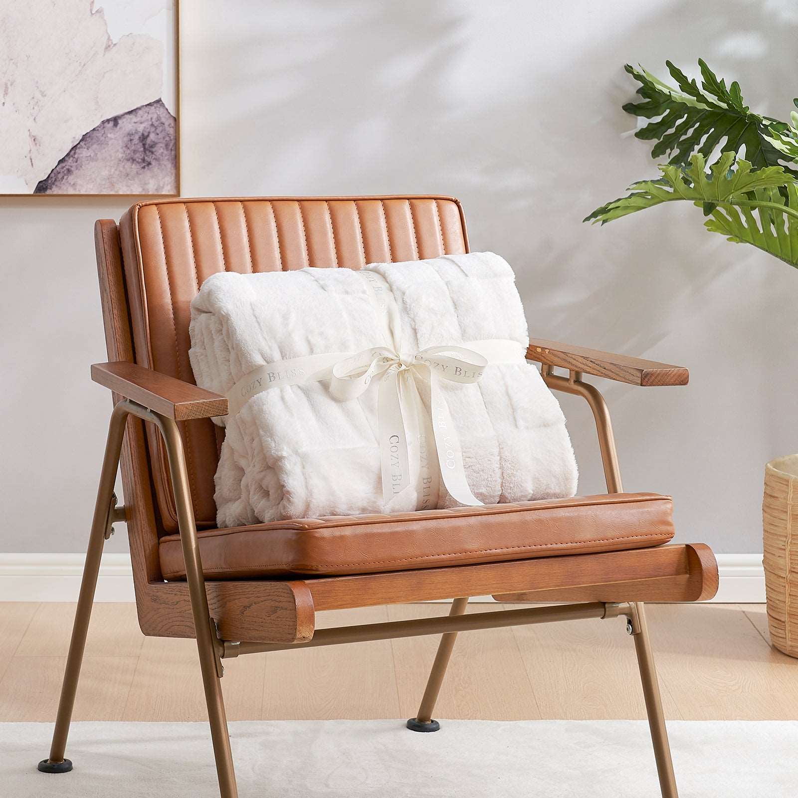 Cozy Bliss faux fur blanket on brown leather armchair, gift idea #color_Ivory