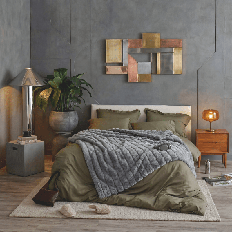 Cozy Bliss sheared faux fur throw blanket layered across the bed in a full room display #color_Grey