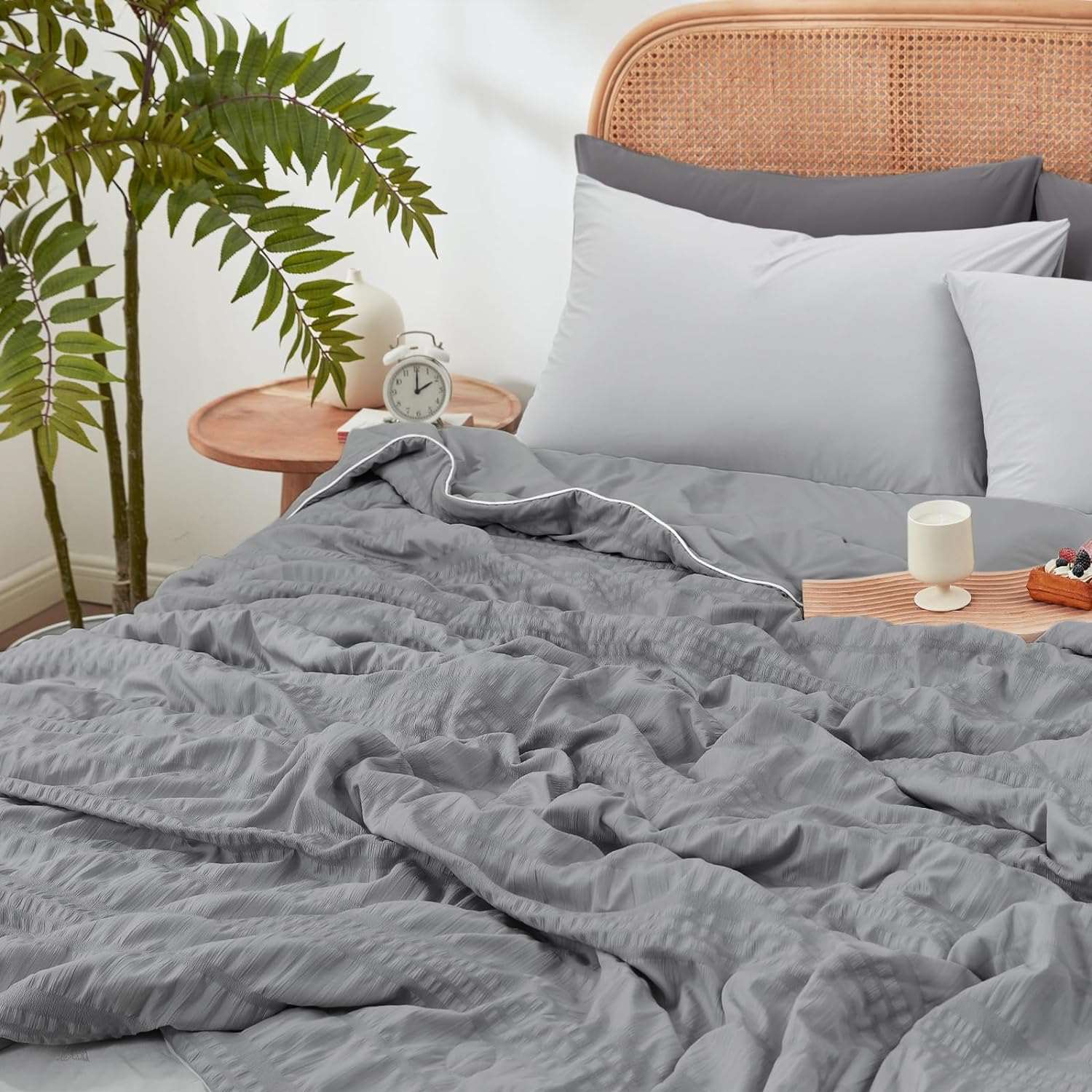Cozy Bliss Seersucker Cooling Comforter on bed, gray color #color_Dark Grey
