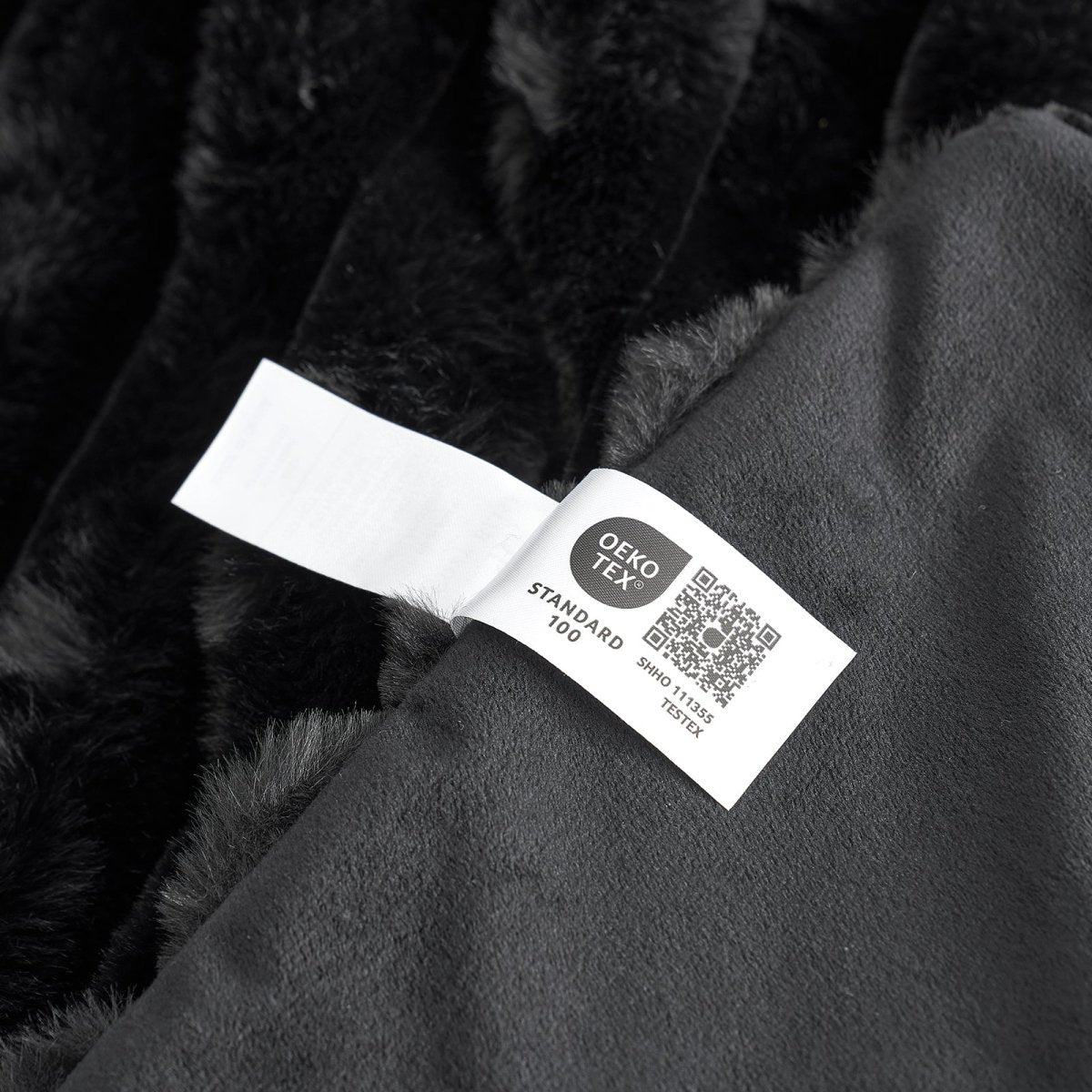 Close-up of OEKO-TEX Certified label of Black Faux Fur Blanket  #color_Black