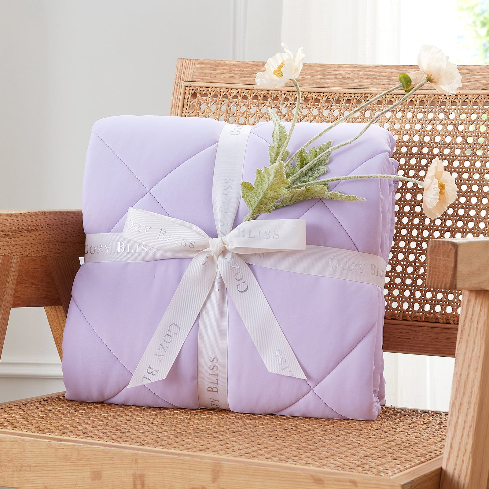 Purple quilt with a white ribbon on a wooden chair  #color_Purple