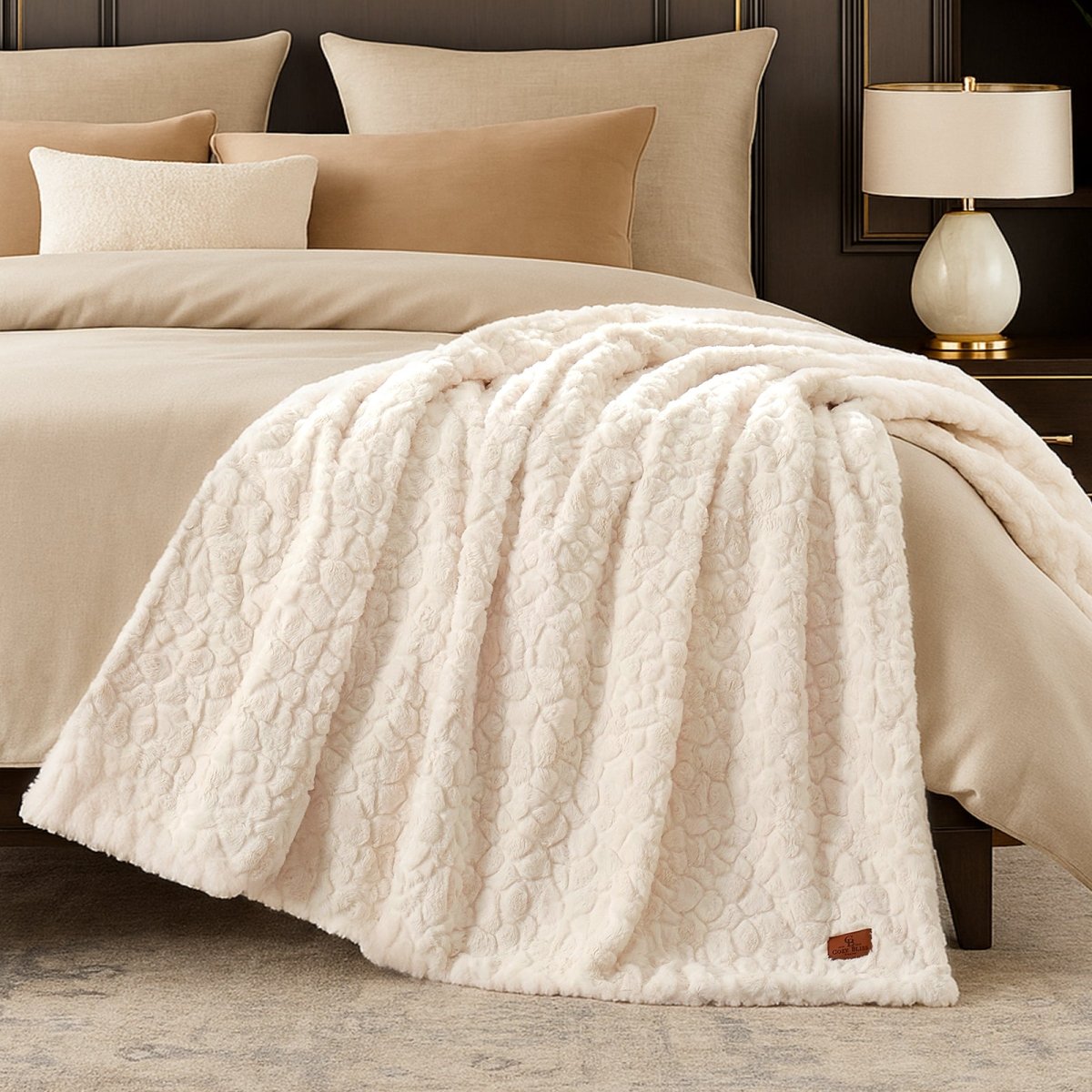 Cozy Bliss premium faux fur throw blanket styled on a bed with a cozy winter atmosphere #color_Cream White