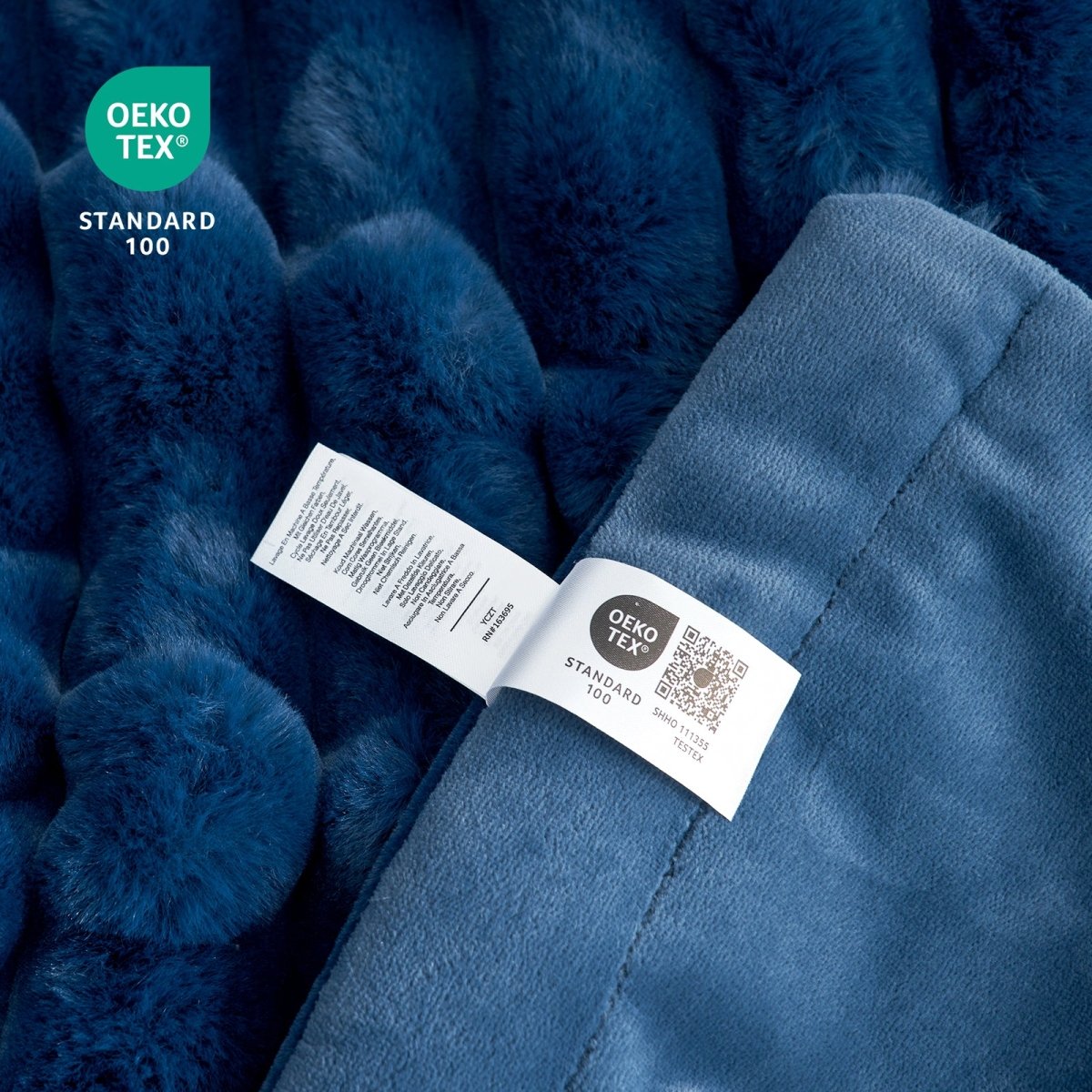 Close-up of Cozy Bliss navy blue striped faux fur blanket Oeko-Tex certified label, soft and cozy bedding for comfort. #color_Navy Blue