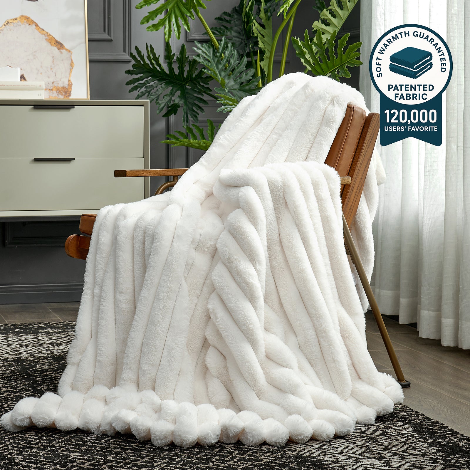 White textured blanket draped over a wooden chair in a room with plants and furniture. #color_Cream White