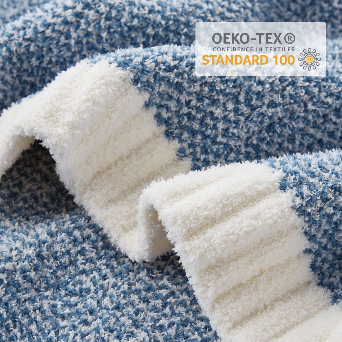 Close-up of Heather Feather Yarn Throw Blanket in Misty Blue showcasing plush texture and OEKO-TEX STANDARD 100 certification. #color_Misty Blue